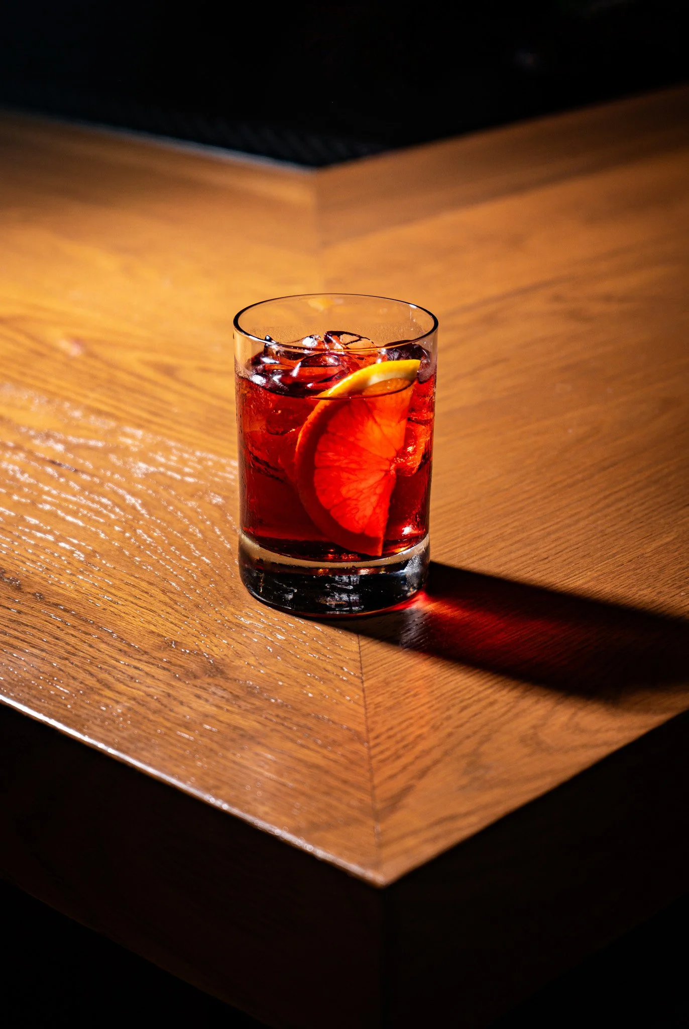 A savory cocktail that uses lighting and shadows to convey color and form.
