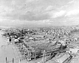 Black and white photo of a cityscape with construction cranes and buildings under construction.