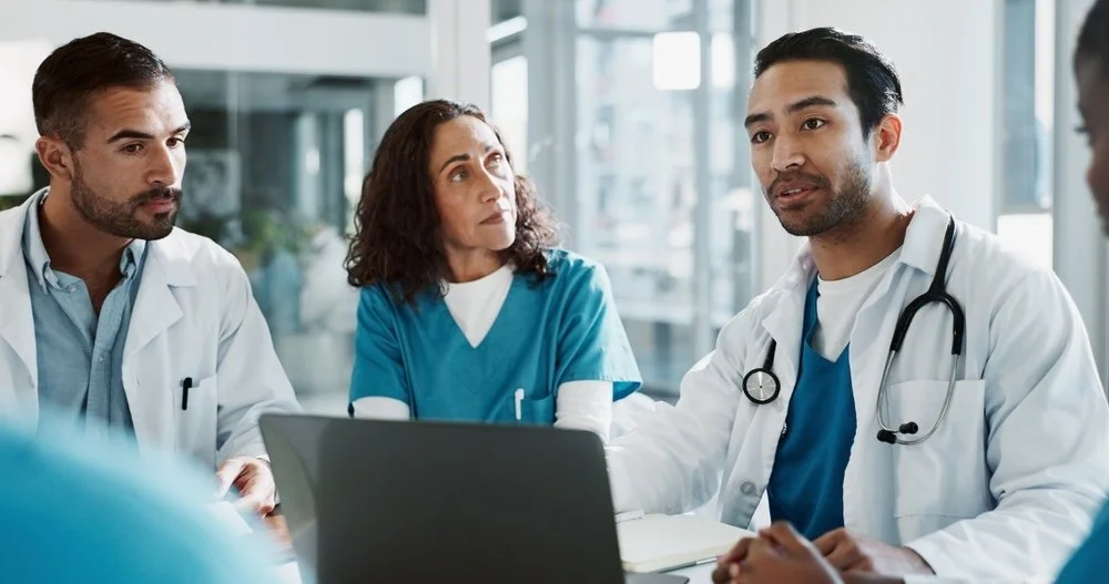 Medical professionals in discussion, in a modern hospital setting.