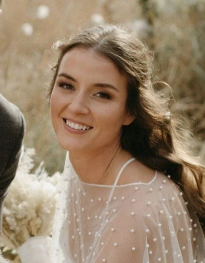 a young woman with long, brown hair wearing a wedding gown