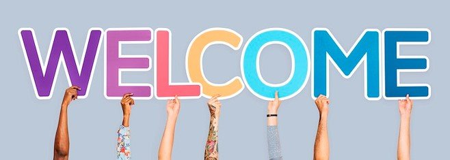 an image of the word Welcome. Each letter is a different color, and is held up by a person's hand. We only see the hands and arms up to the elbow. They are a variety of skin tones. some have long sleeves, and one has a tattoo sleeve.