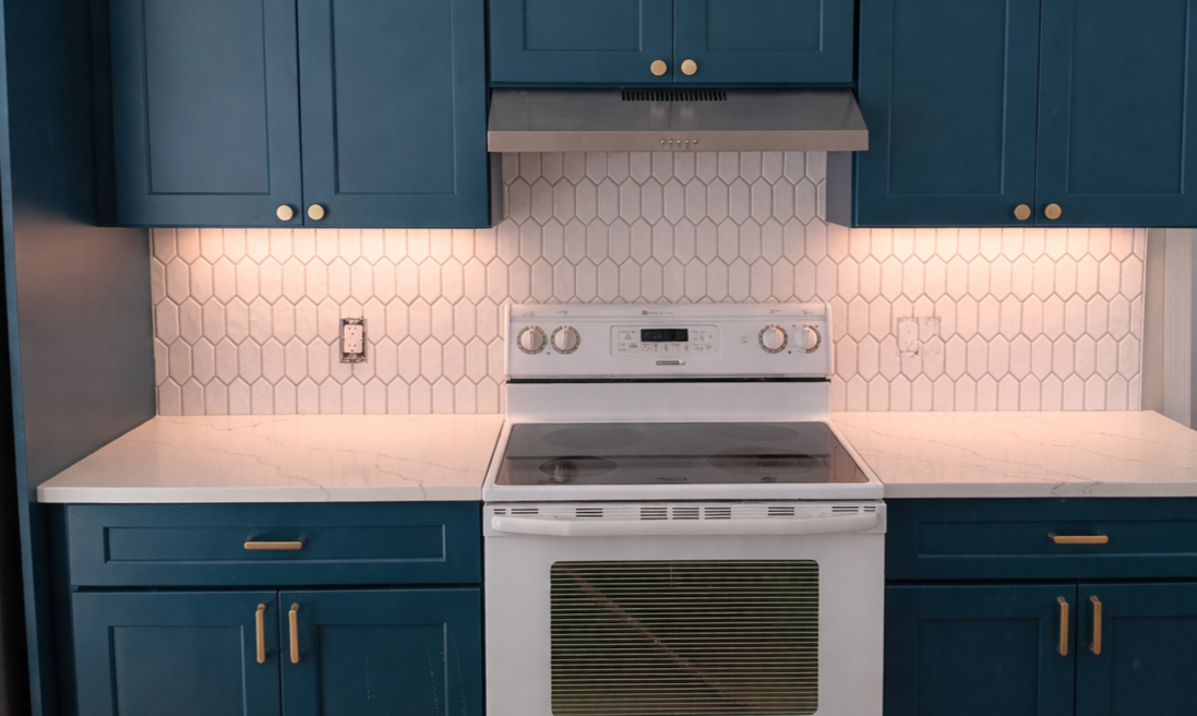 White hexagon kitchen backsplash tile installation. Ceramic/porcelain wall tile for durable, moisture-resistant, modern kitchen backsplash design and remodel projects.