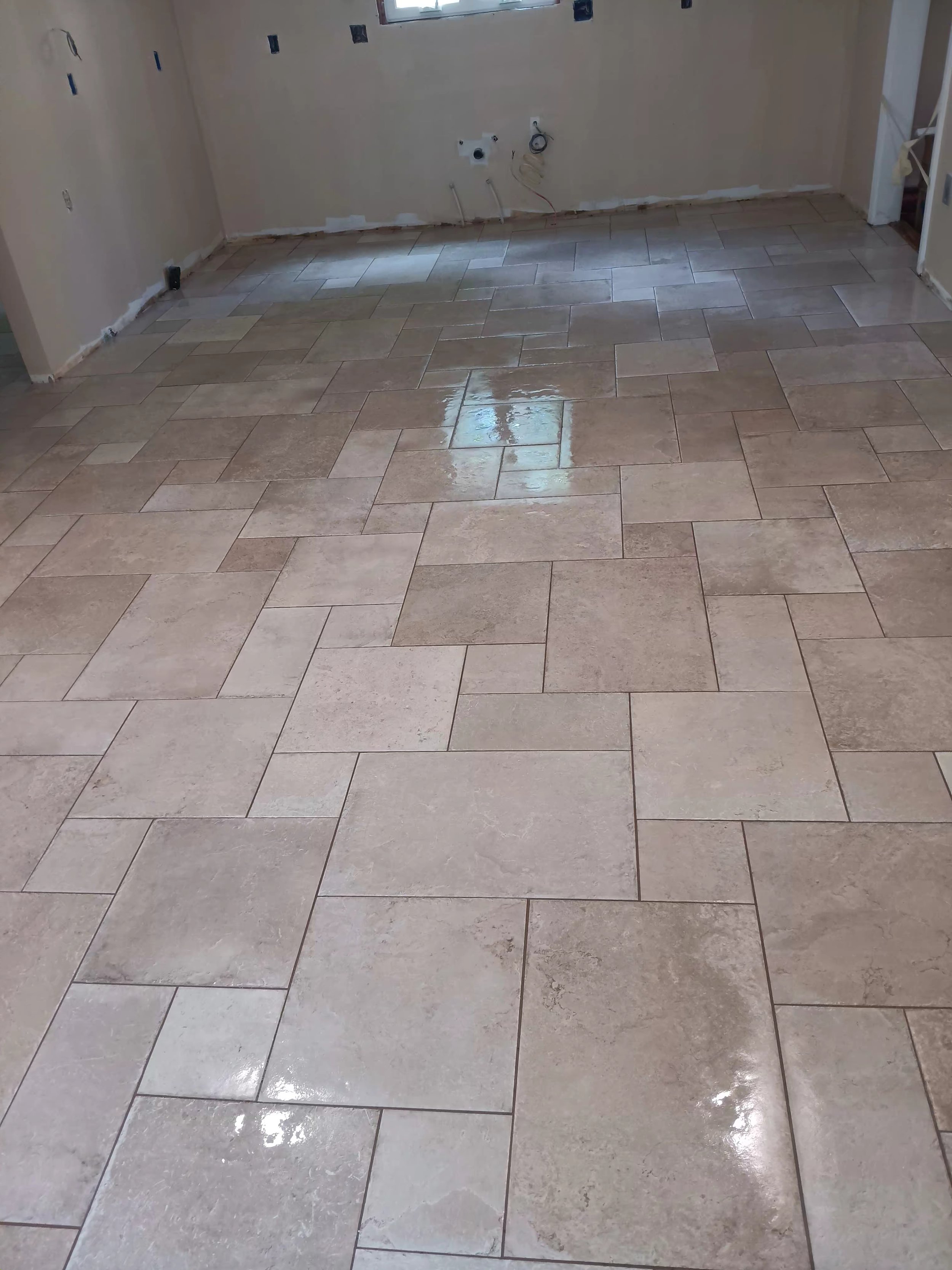A room with beige tile flooring