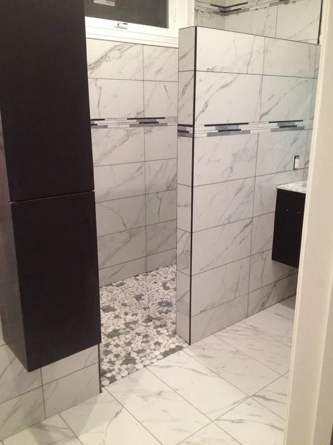 Part of a modern bathroom with white marble tiles