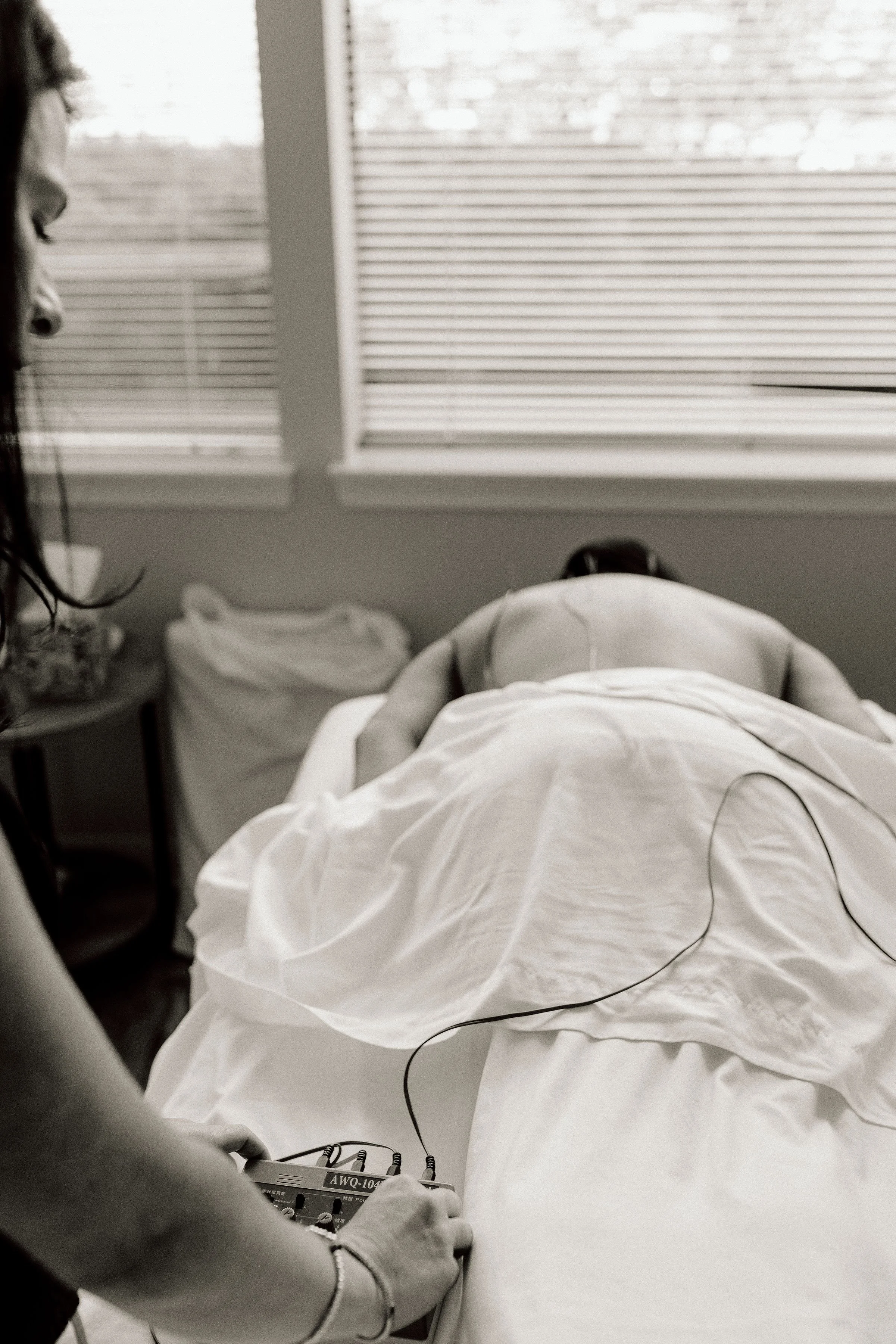 A patient receiving electroacupuncture by a licensed acupuncturist