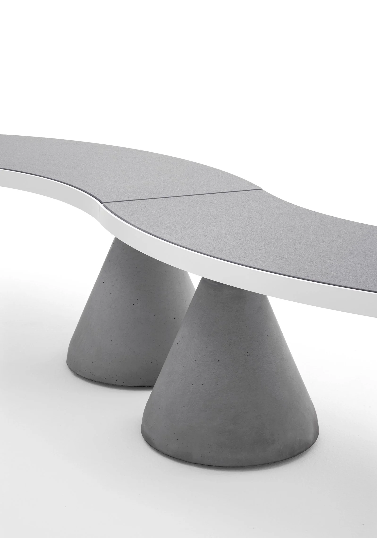 Sempreverde.040 curved bench featuring Laptiec sintered stone surface &  cement cone legs