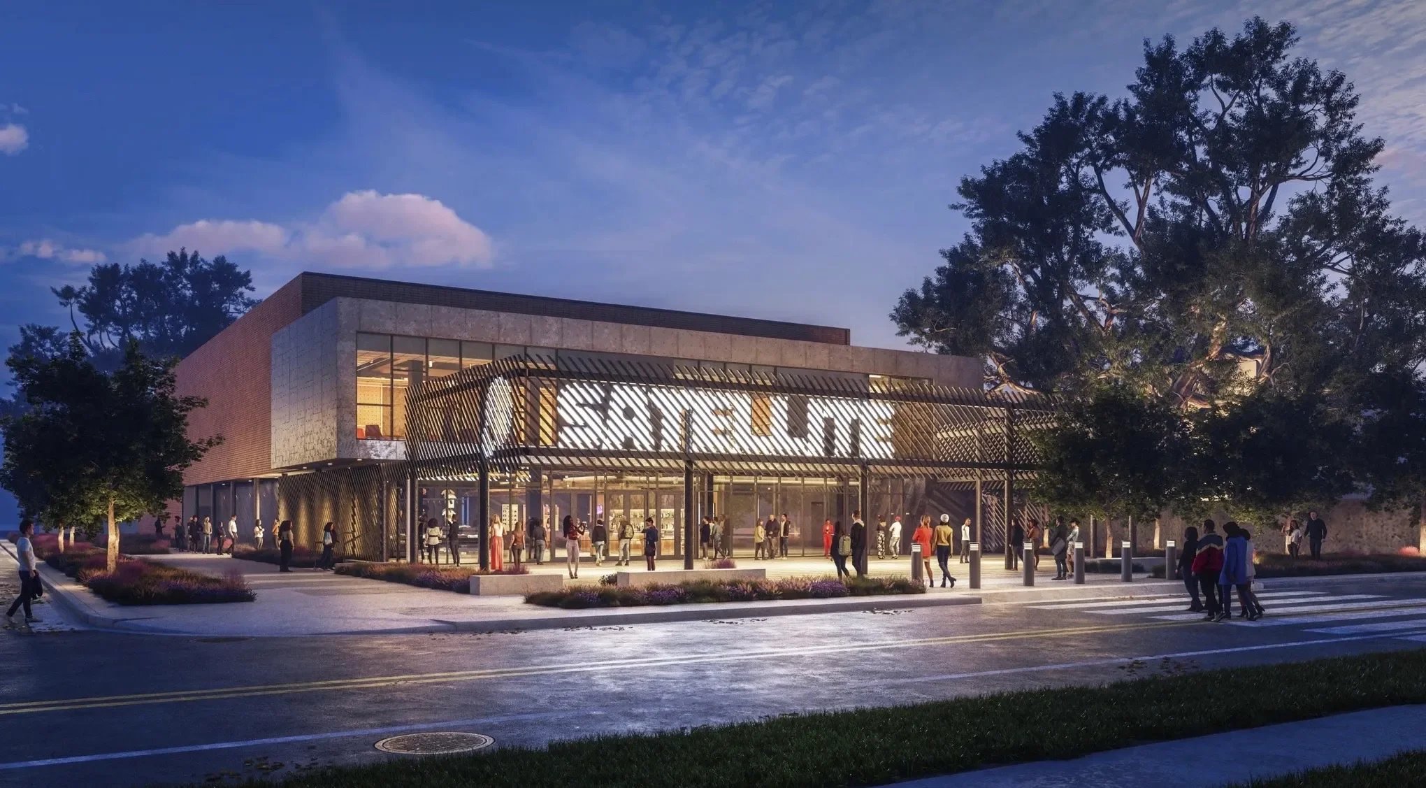 Night view of a modern retail store with large illuminated "STORE" sign, glass entrance, and people walking around the sidewalk and parking area.