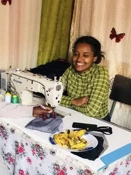 Lidia at sewing machine