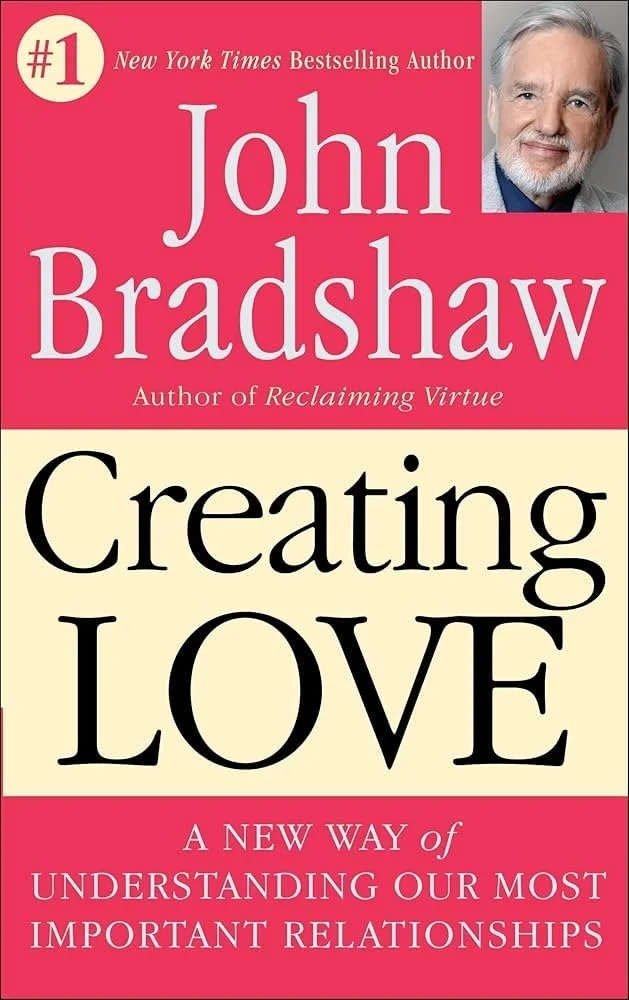 Book cover titled 'Creating Love: A New Way of Understanding Our Most Important Relationships' by John Bradshaw, with a photo of the author in the top right corner and a red and beige color scheme.