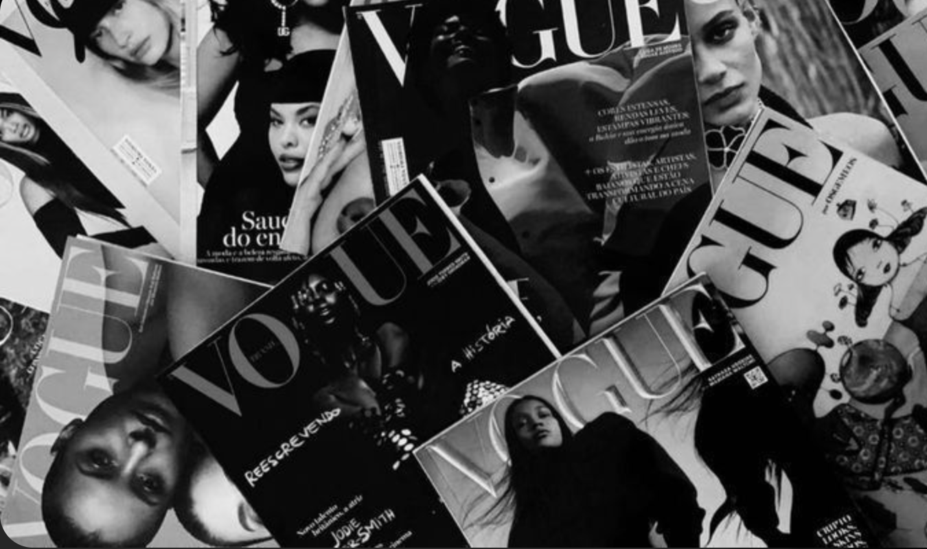 Black and white magazines spread out with fashion-covered models, celebrities, and illustrations on the covers.