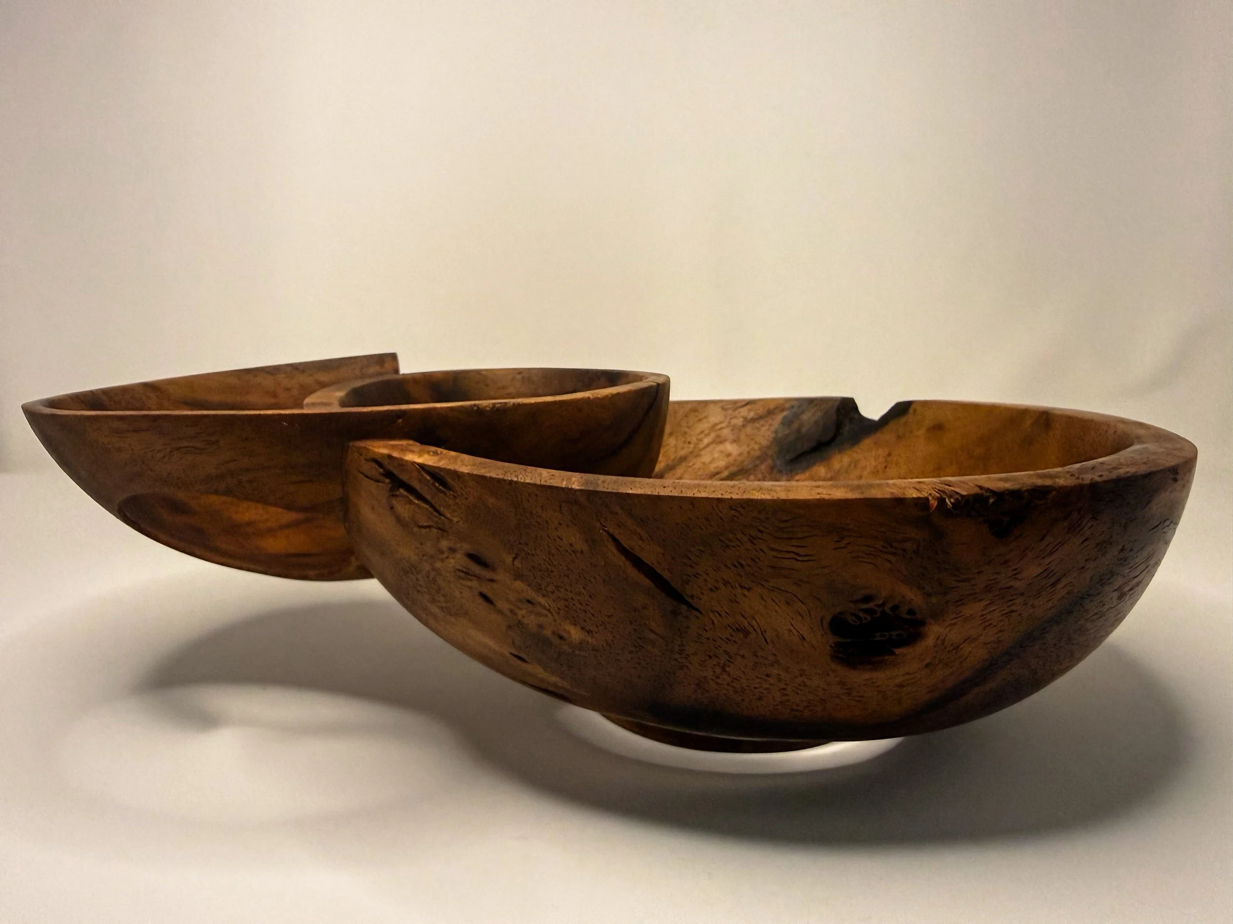 Profile view of hand-carved walnut sculptural bowl titled Taper by Smoke & Ember Studios