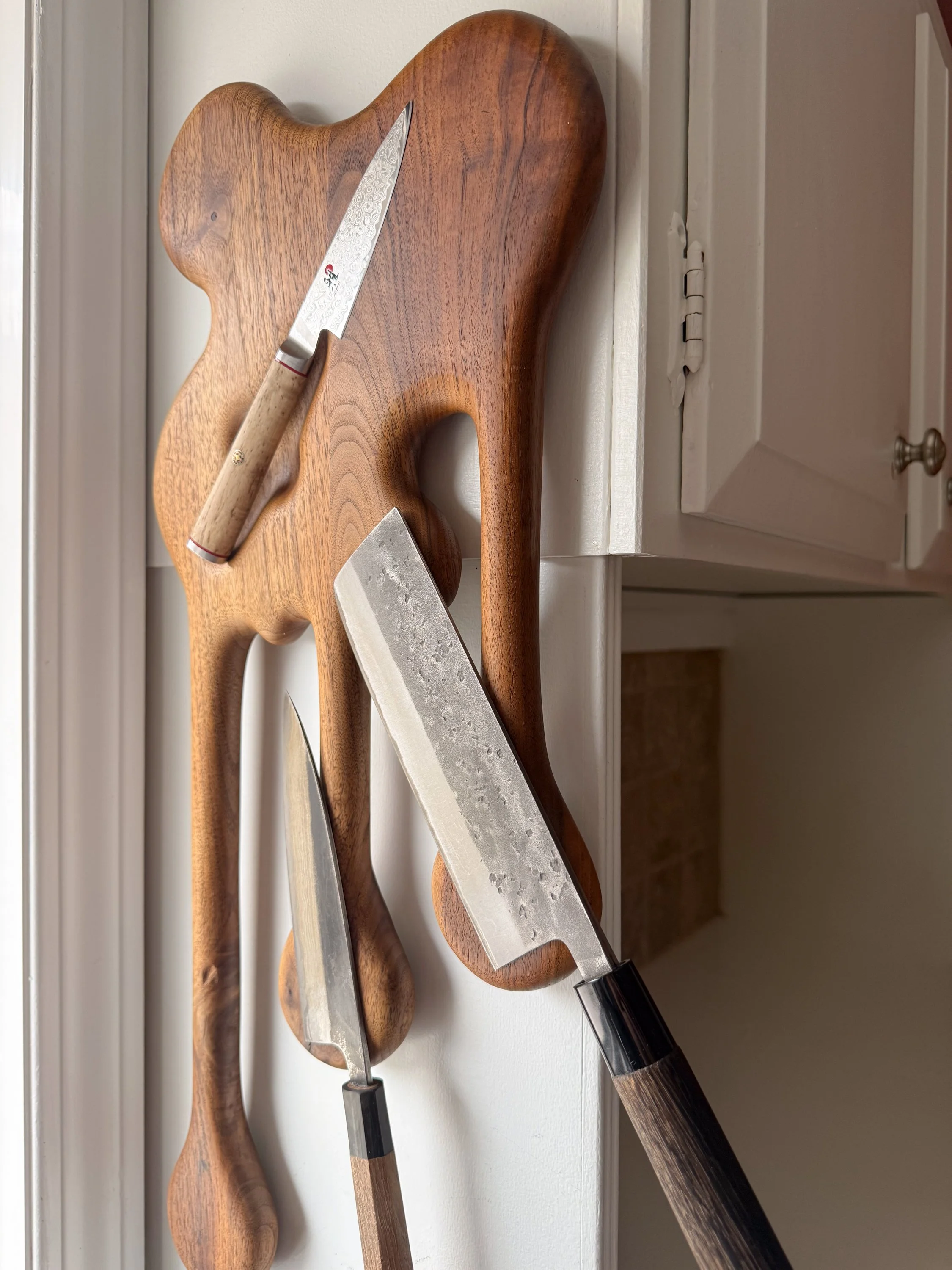 Functional view of sculptural walnut magnetic knife block titled Drip by Smoke & Ember Studios