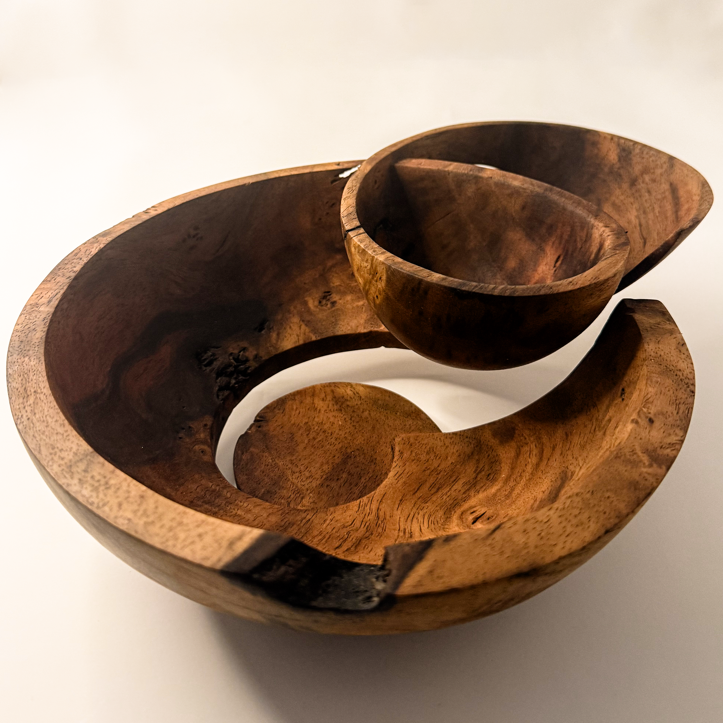 Hand-carved walnut sculptural bowl titled Taper by Smoke & Ember Studios
