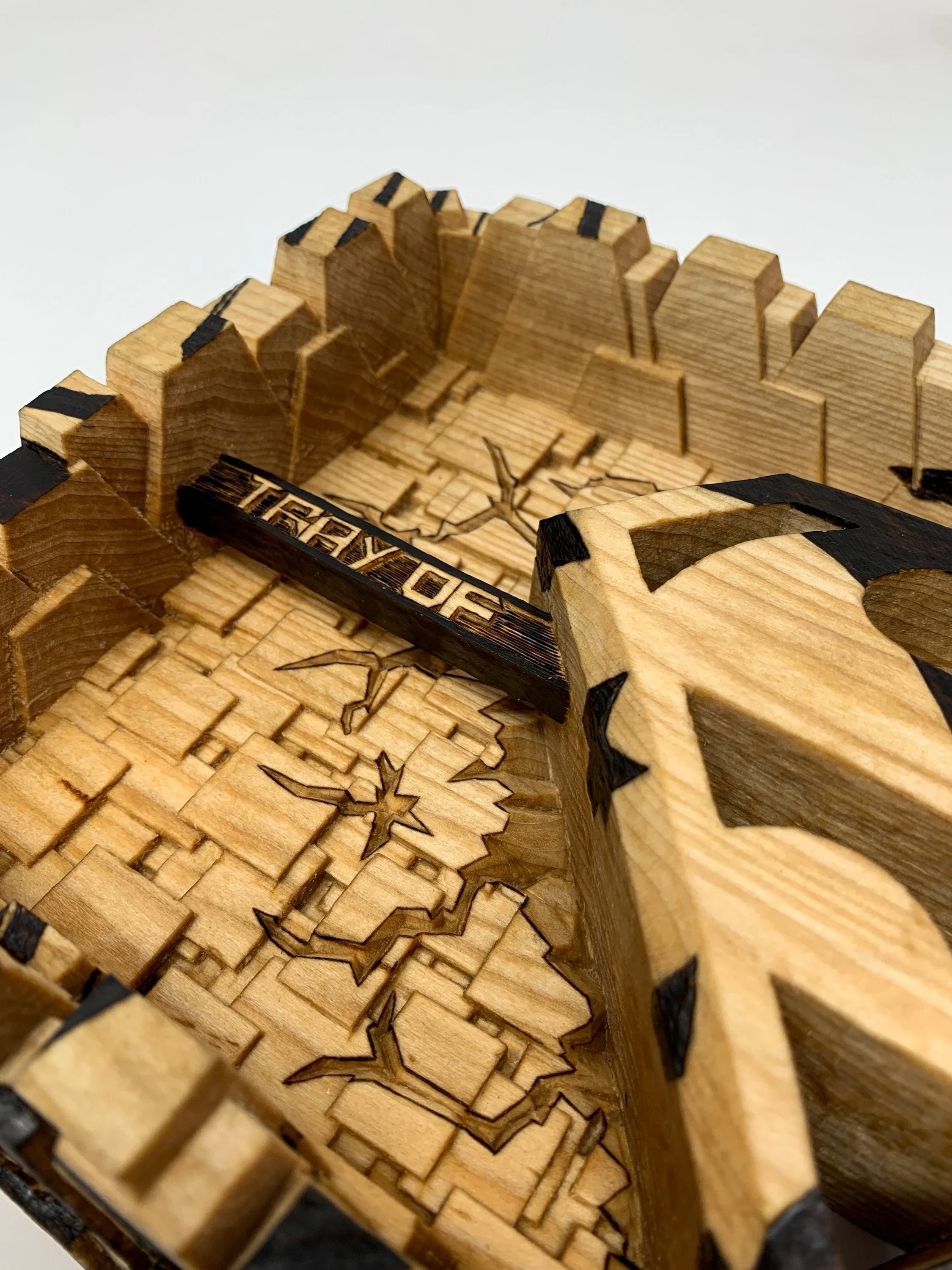 Isometric view of carved basswood sculpture titled Marked by Smoke & Ember Studios