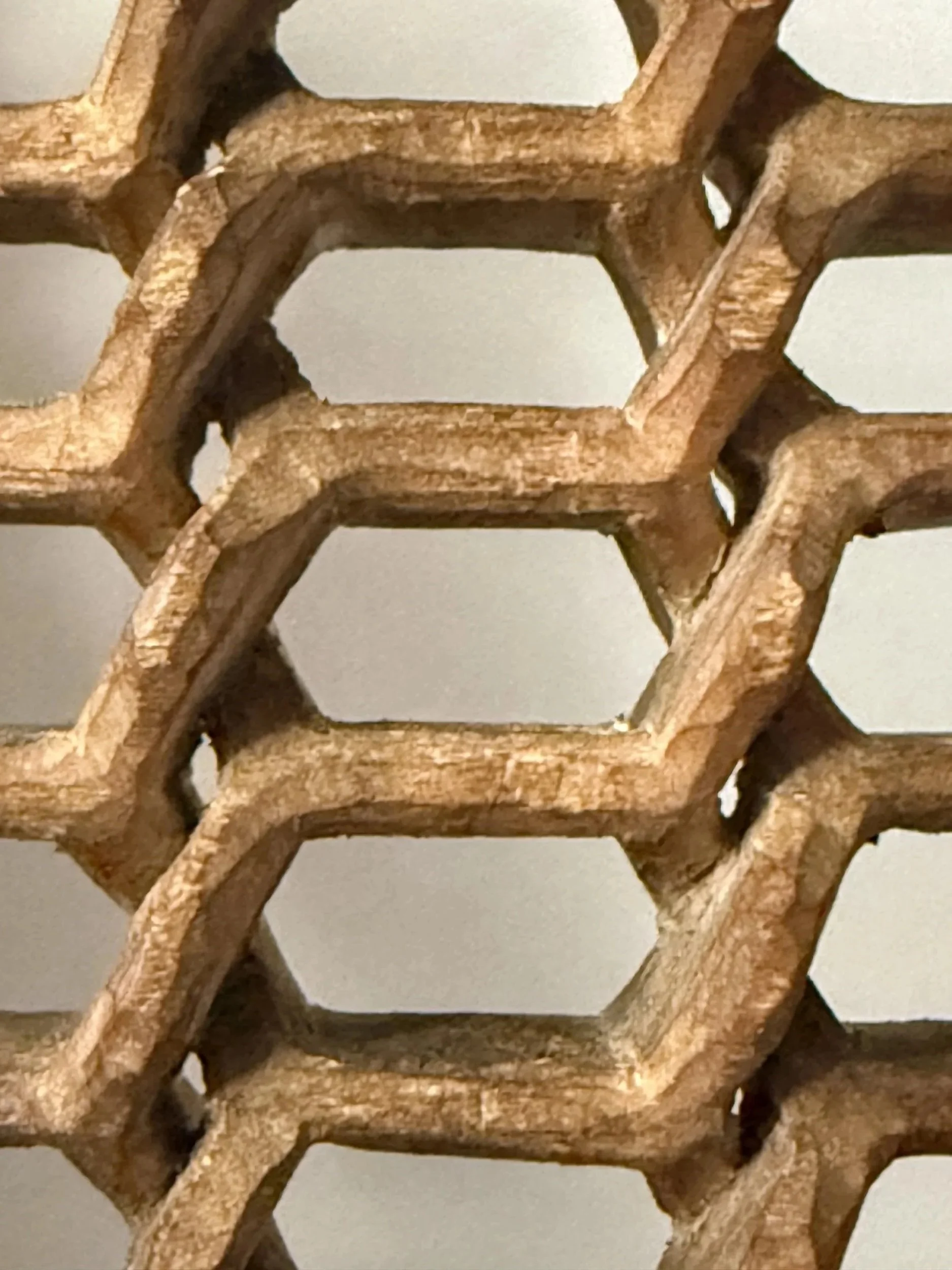 Detail view of geometric carved wood sculpture titled HEX by Smoke & Ember Studios