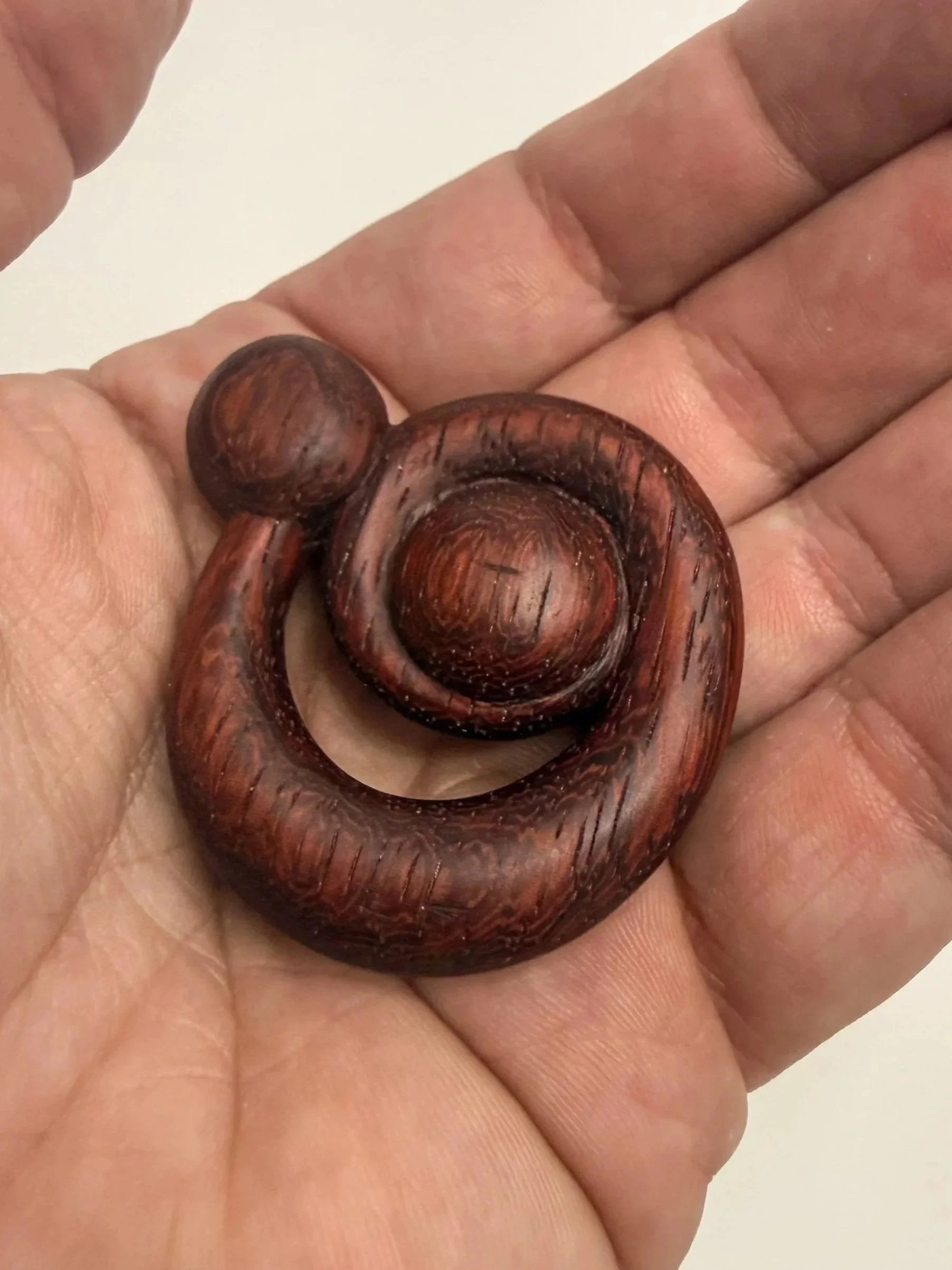 Handheld sculptural wood study titled Polaris held in hand