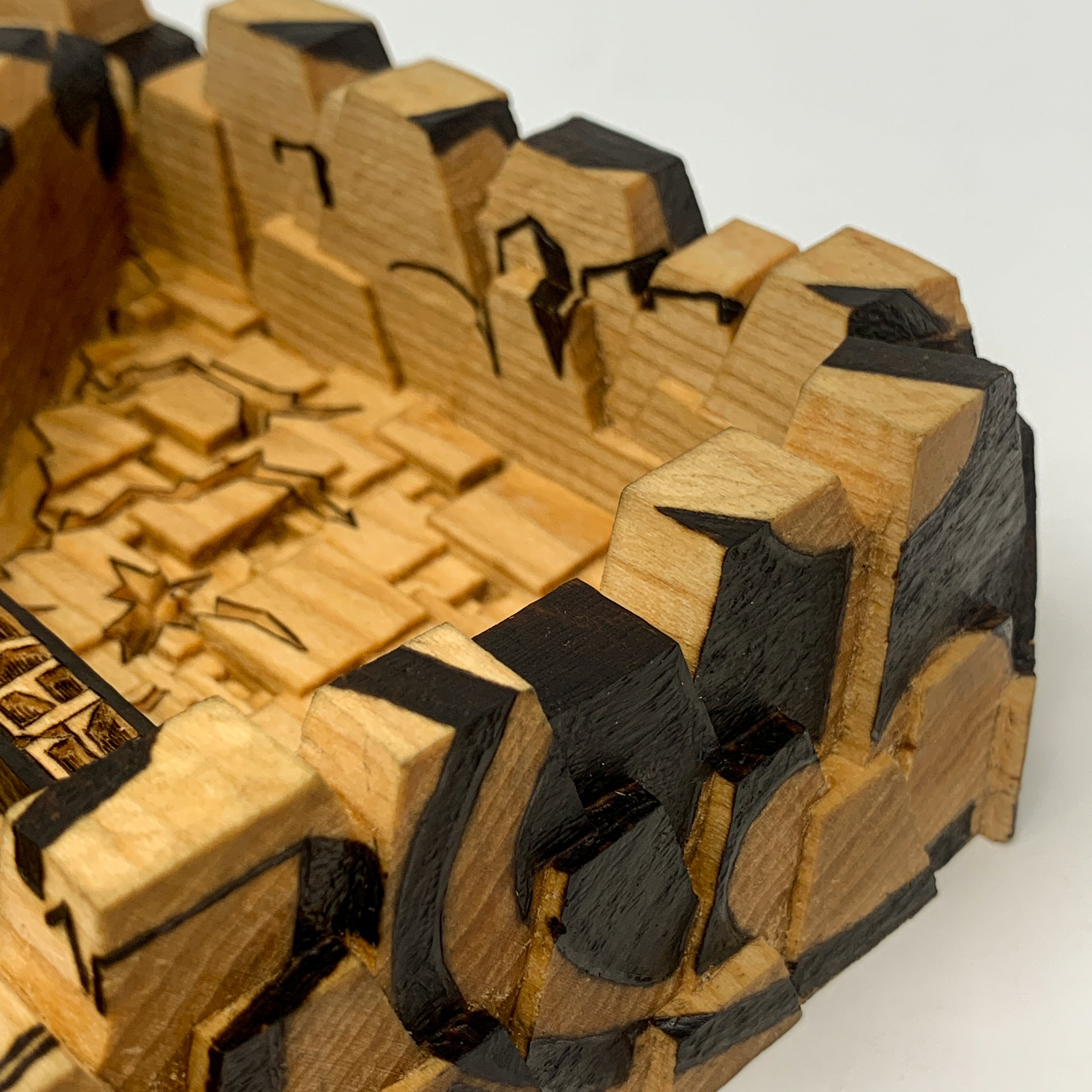 Detail view of carved basswood sculpture titled Marked by Smoke & Ember Studios