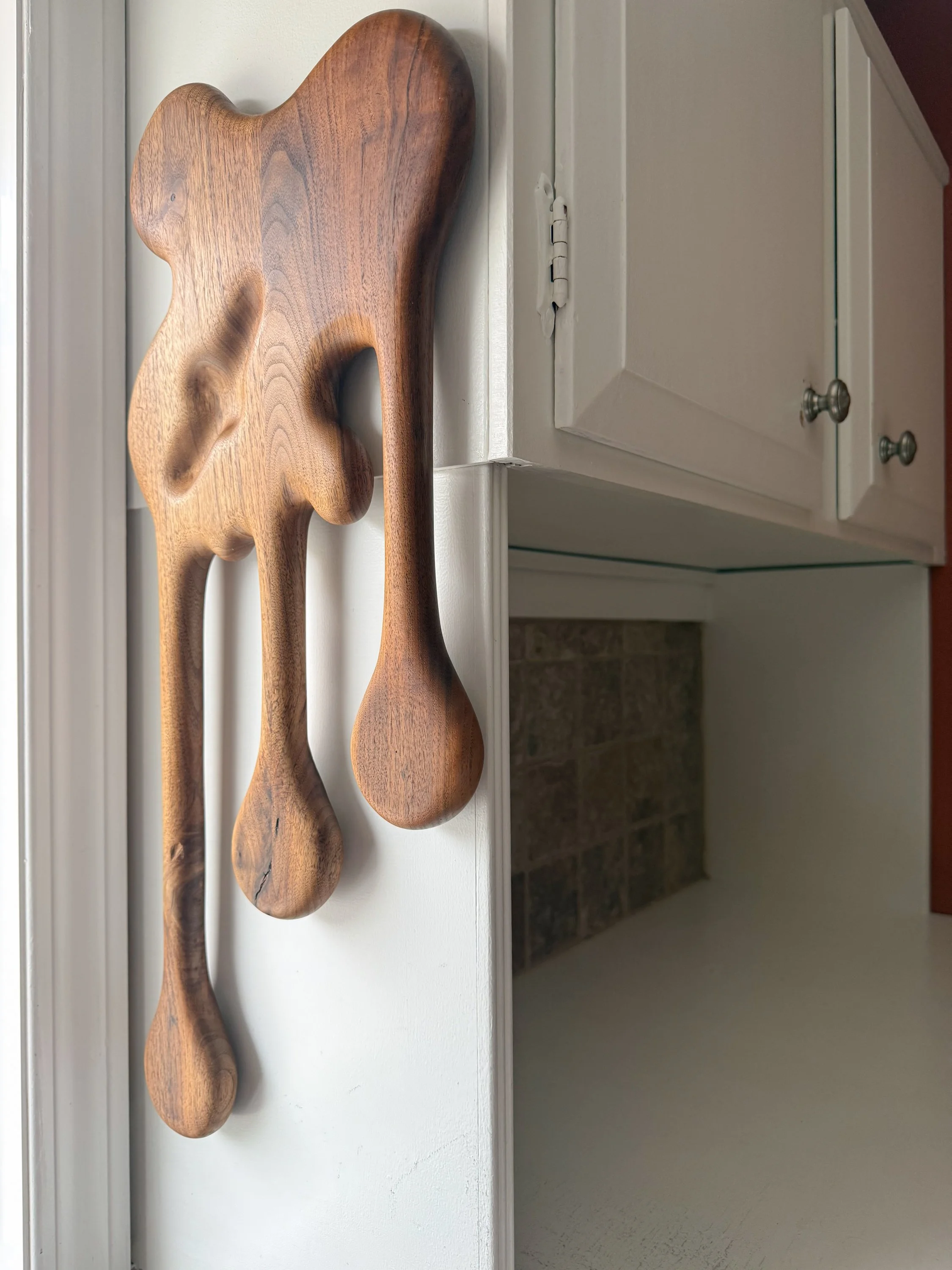 Placed view of sculptural walnut magnetic knife block titled Drip by Smoke & Ember Studios