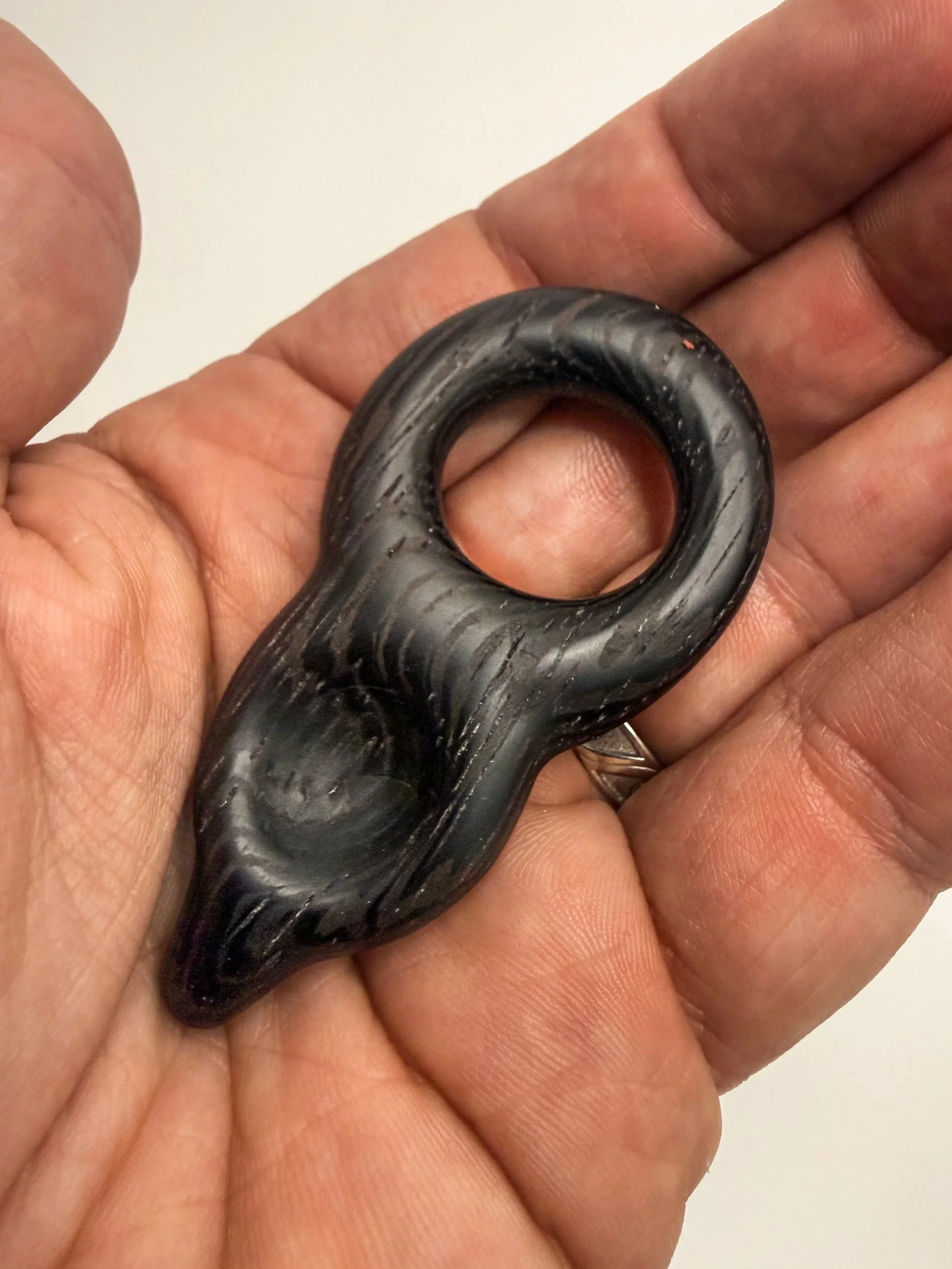 Handheld sculptural wood study titled Meridian held in hand