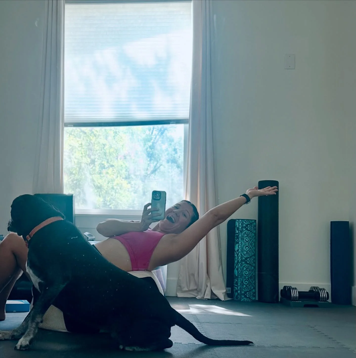 Melissa Acocsta, bold founder of mama wears pants, exercising with her black dog.