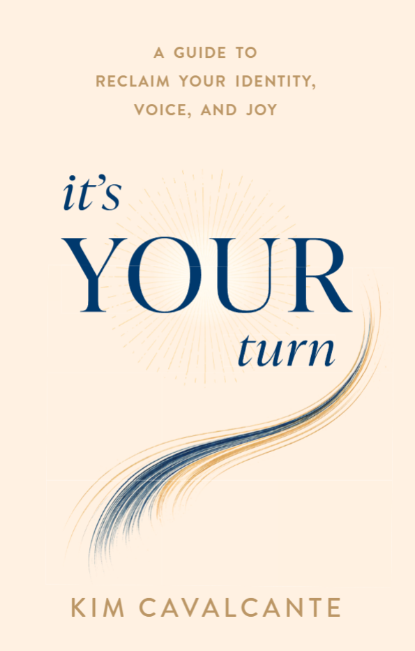 Book cover titled "It's Your Turn" by Kim Cavalcante. The subtitle is "A Guide to Reclaim Your Identity, Voice, and Joy." The background is light beige with a radiating sunburst design behind the title, and a sweeping curved line below.