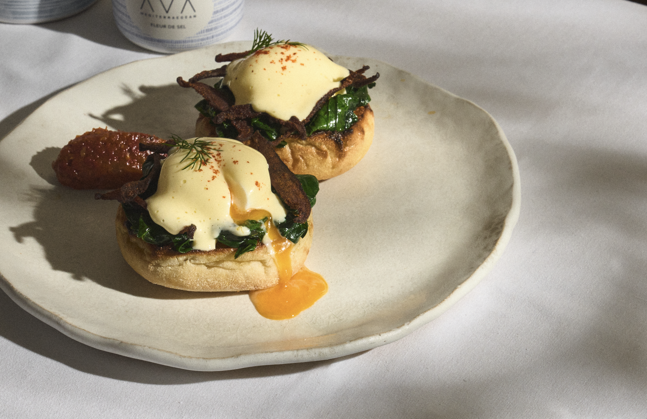 AVA's brunch menu item, eggs benedict, on a plate.