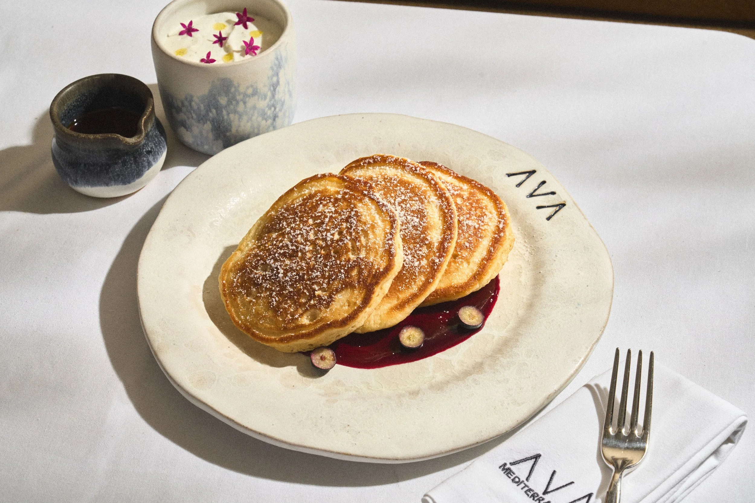 AVA's Brunch menu item, pancakes with a side of whipping for the top.