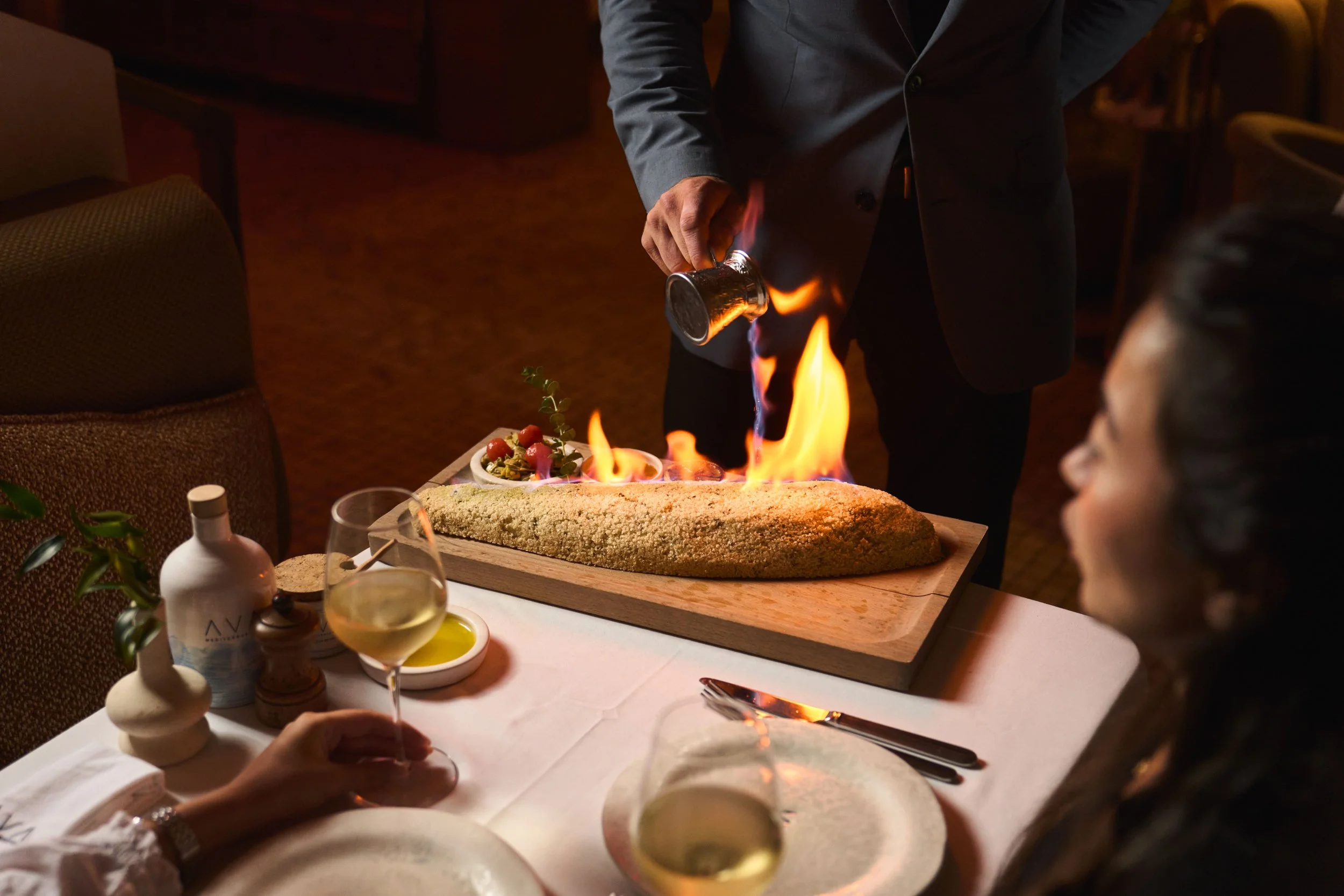 An exciting dining experience with seeing a salted covered fish light up with fire at AVA Coconut Grove.