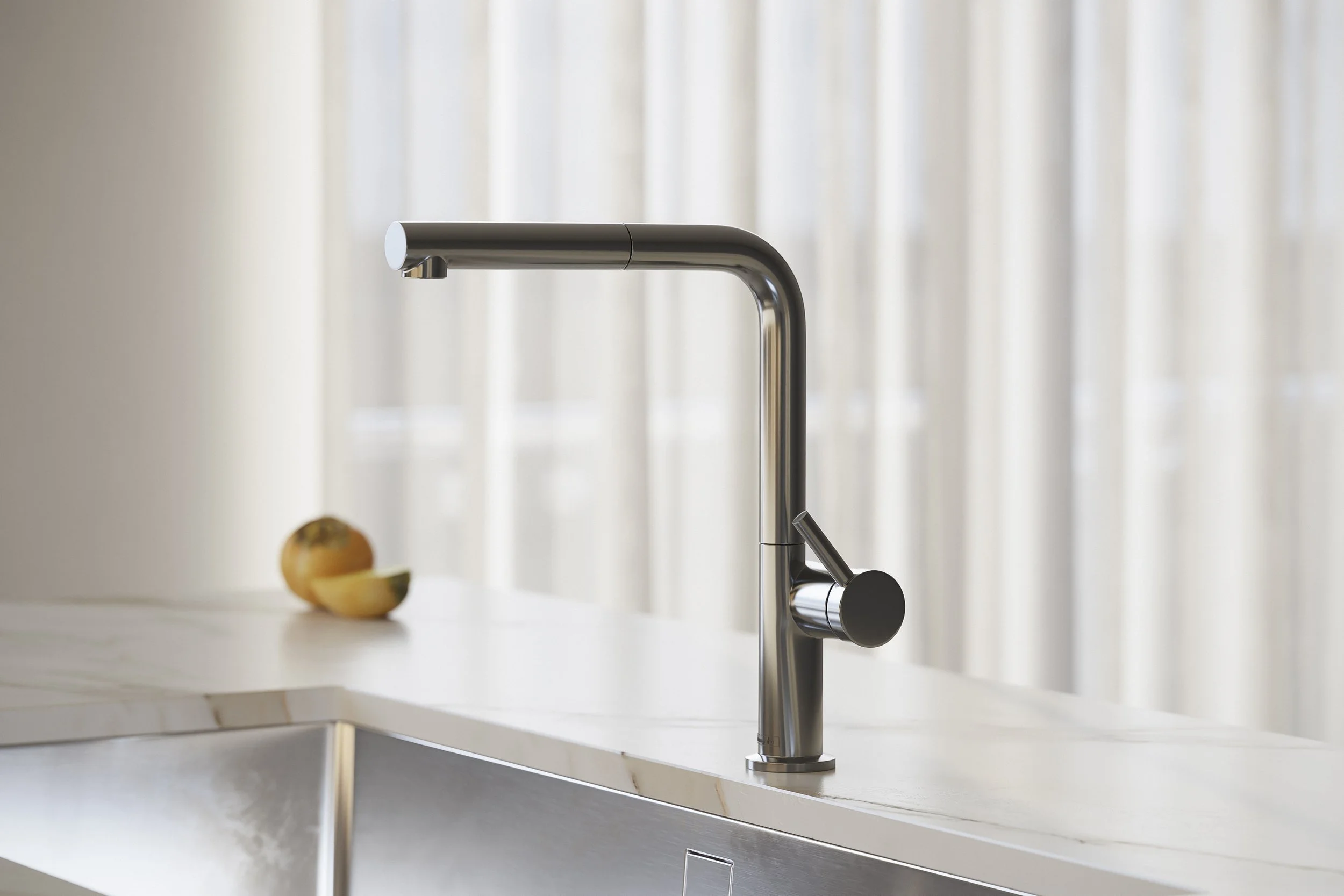 Modern kitchen faucet on white sink, with a sliced apple on the countertop, and light sheer curtains in the background