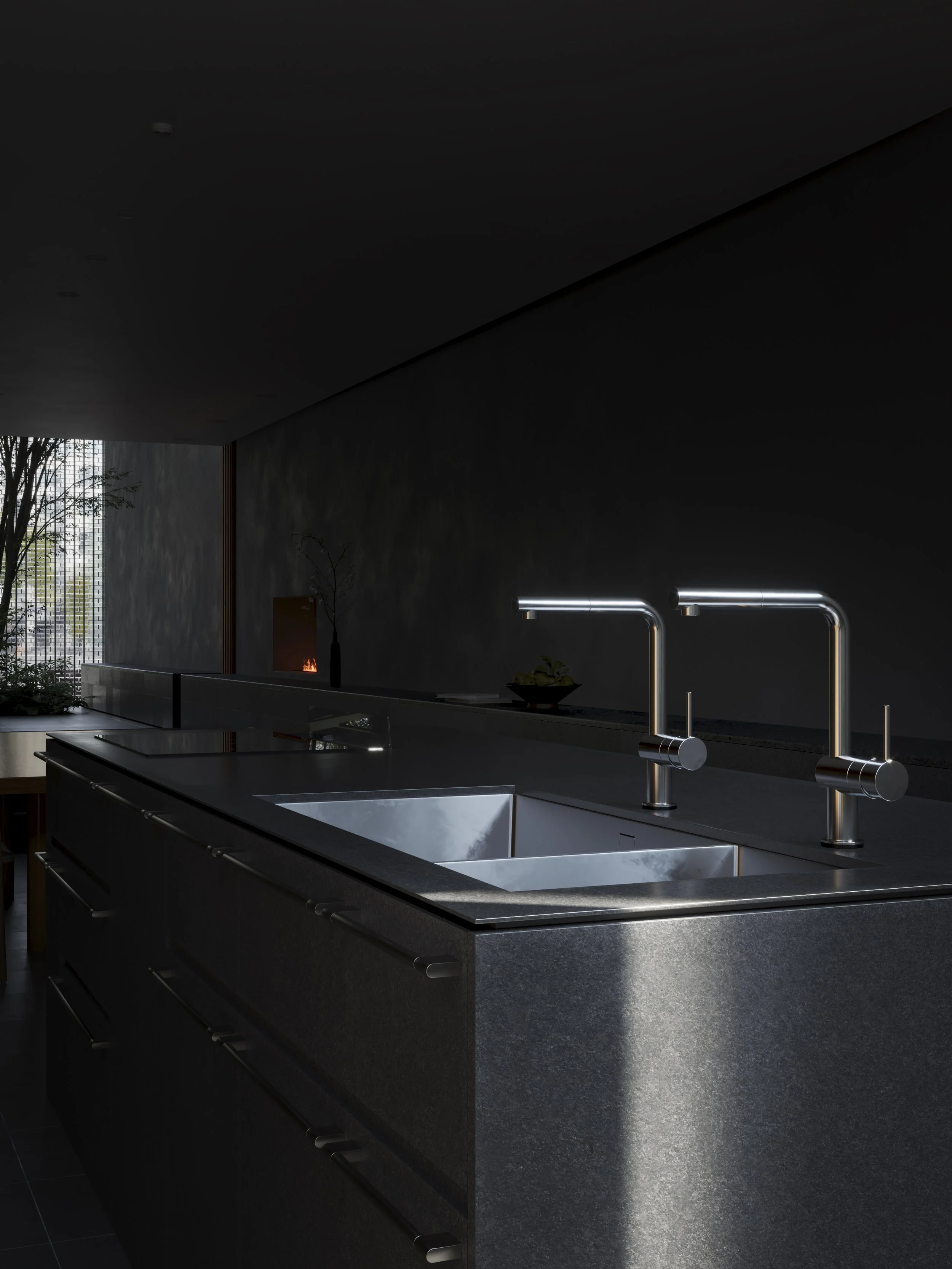 Modern kitchen with dual stainless steel sinks, black countertops, sleek chrome faucets, and a dark wall with a small fireplace and large window with trees outside.
