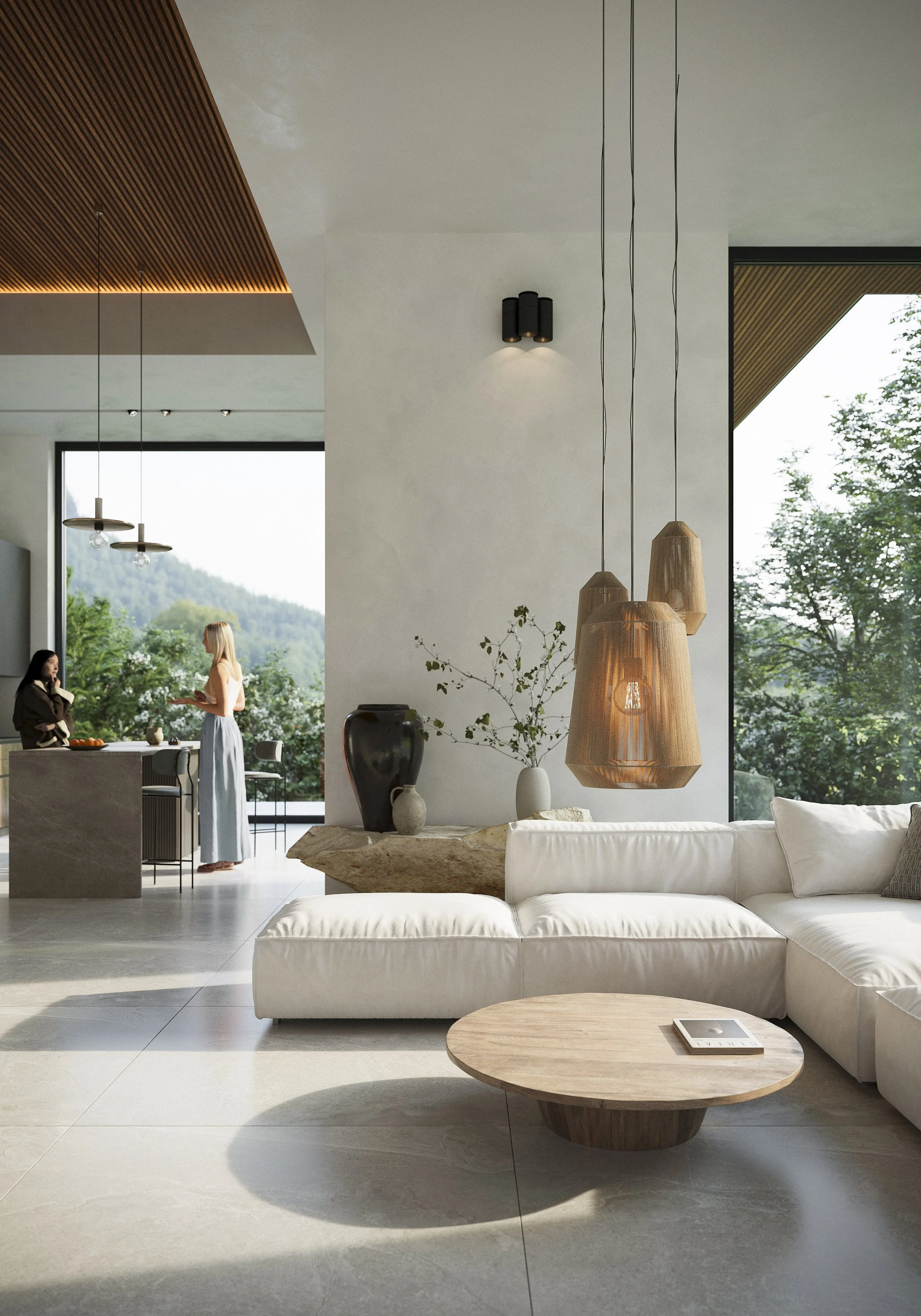 Modern living room interior with white sectional sofa, wooden round coffee table, pendant lights, decorative vases, and large windows showing green trees outside.