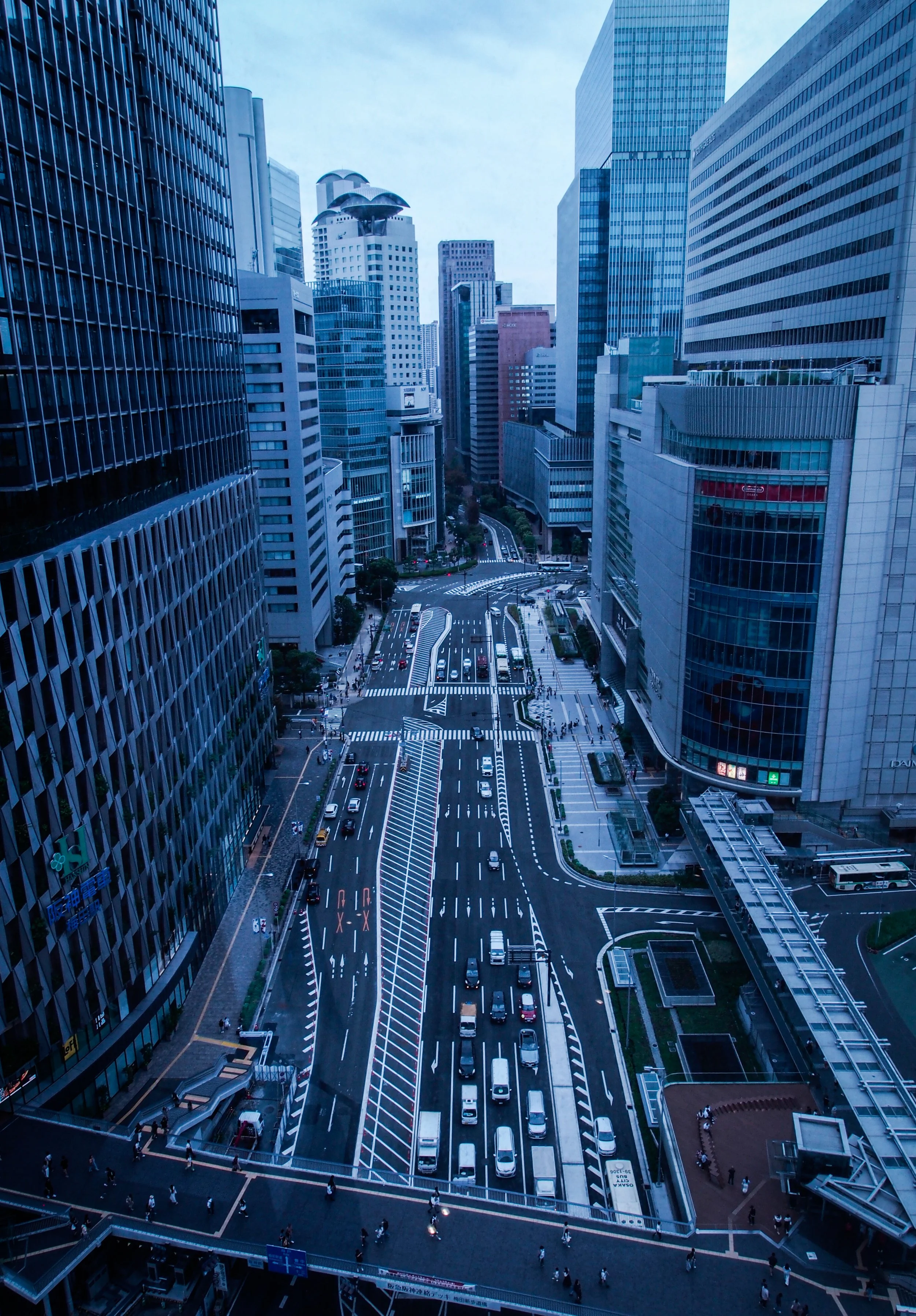 Aerial view of a busy city street with high-rise buildings and cars.