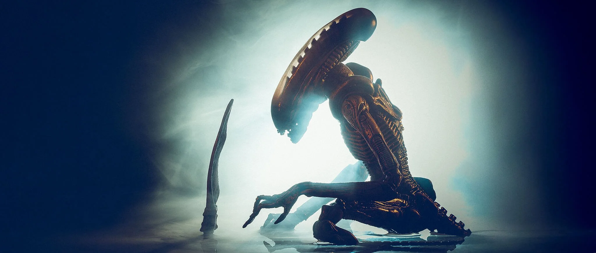 A sci-fi creature with a biomechanical, insect-like appearance, crouching in a misty, dimly lit environment.