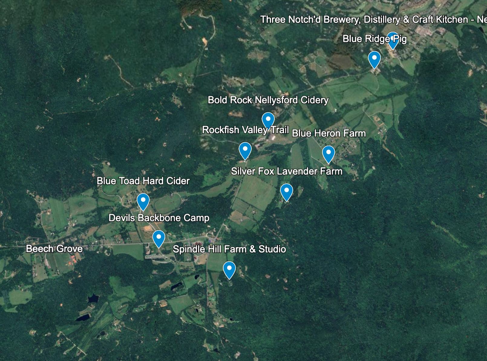 Satellite map of a rural area showing various farms, cideries, and a brewery, with labels indicating the locations of Blue Ridge Pig, Bold Rock Nellysford Cidery, Rockfish Valley Trail, Silver Fox Lavender Farm, Blue Heron Farm, Devils Backbone Camp, Spindle Hill Farm & Studio, Blue Toad Hard Cider, and Beech Grove.