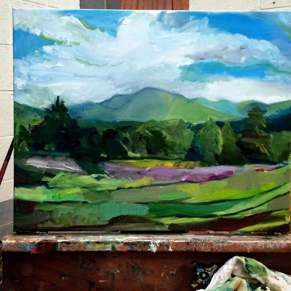 A landscape painting featuring green rolling hills, purple fields, a line of trees, and distant mountains under a partly cloudy sky.