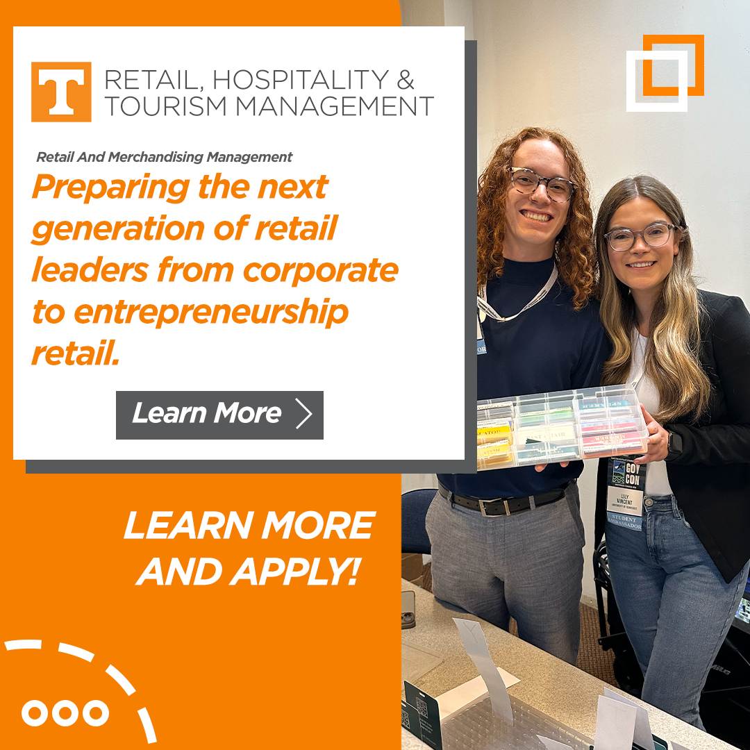 Two women smiling and holding a plastic storage container with colorful items inside, standing indoors in front of a promotional poster about retail, hospitality, and tourism management.