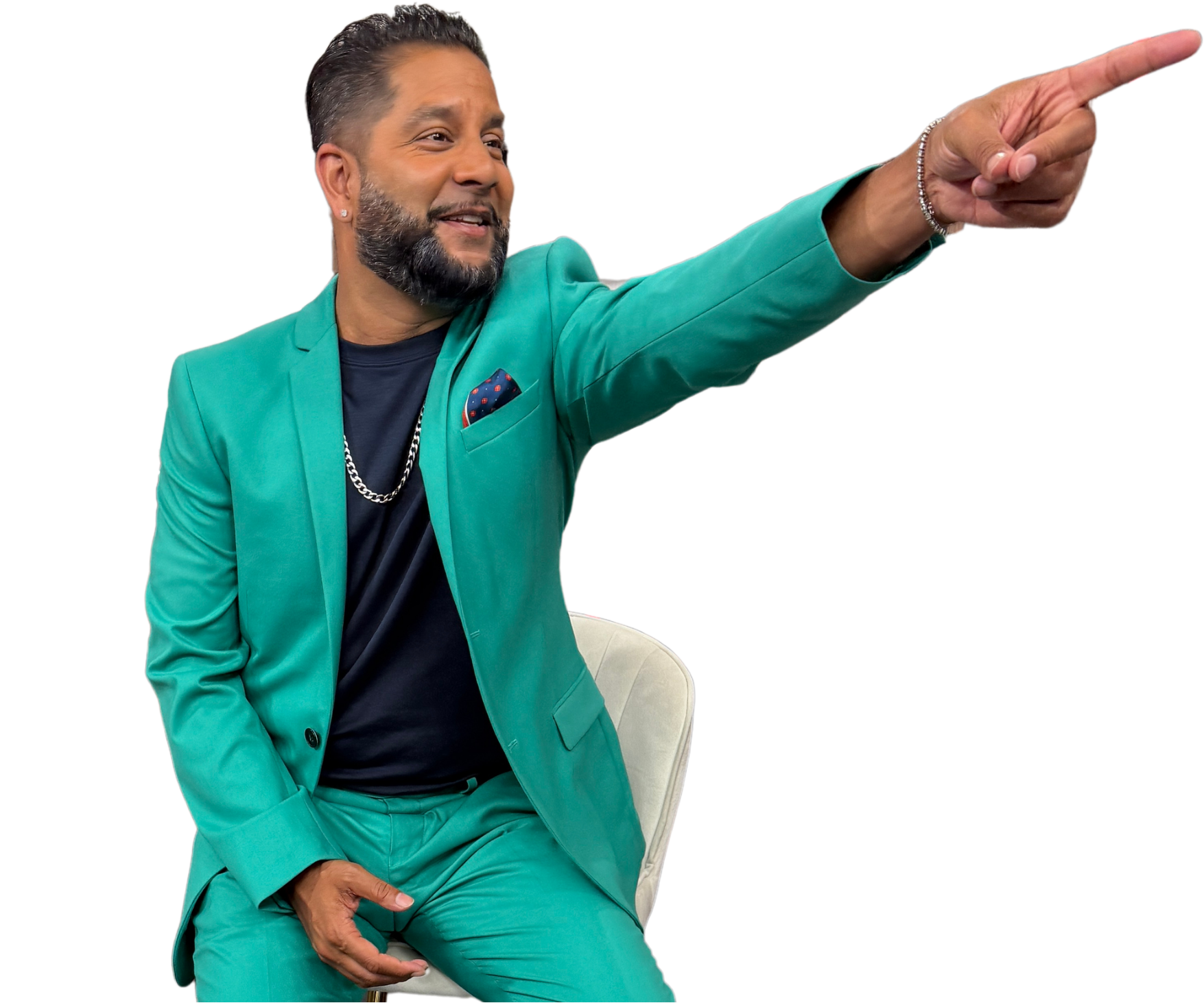 Devo Brown seated and pointing in a teal suit against a purple background