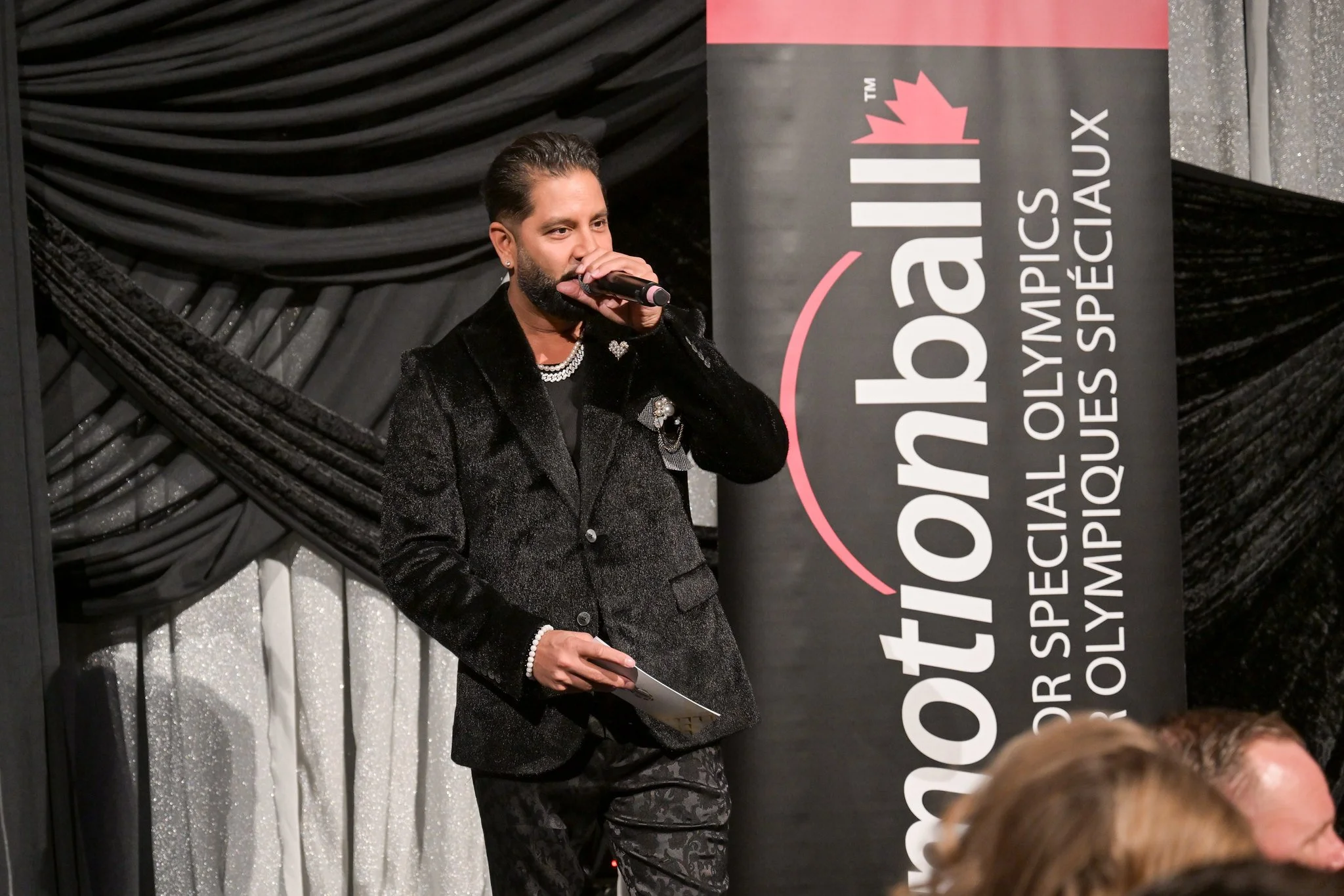 Devo Brown hosting a corporate event on stage - Motionball