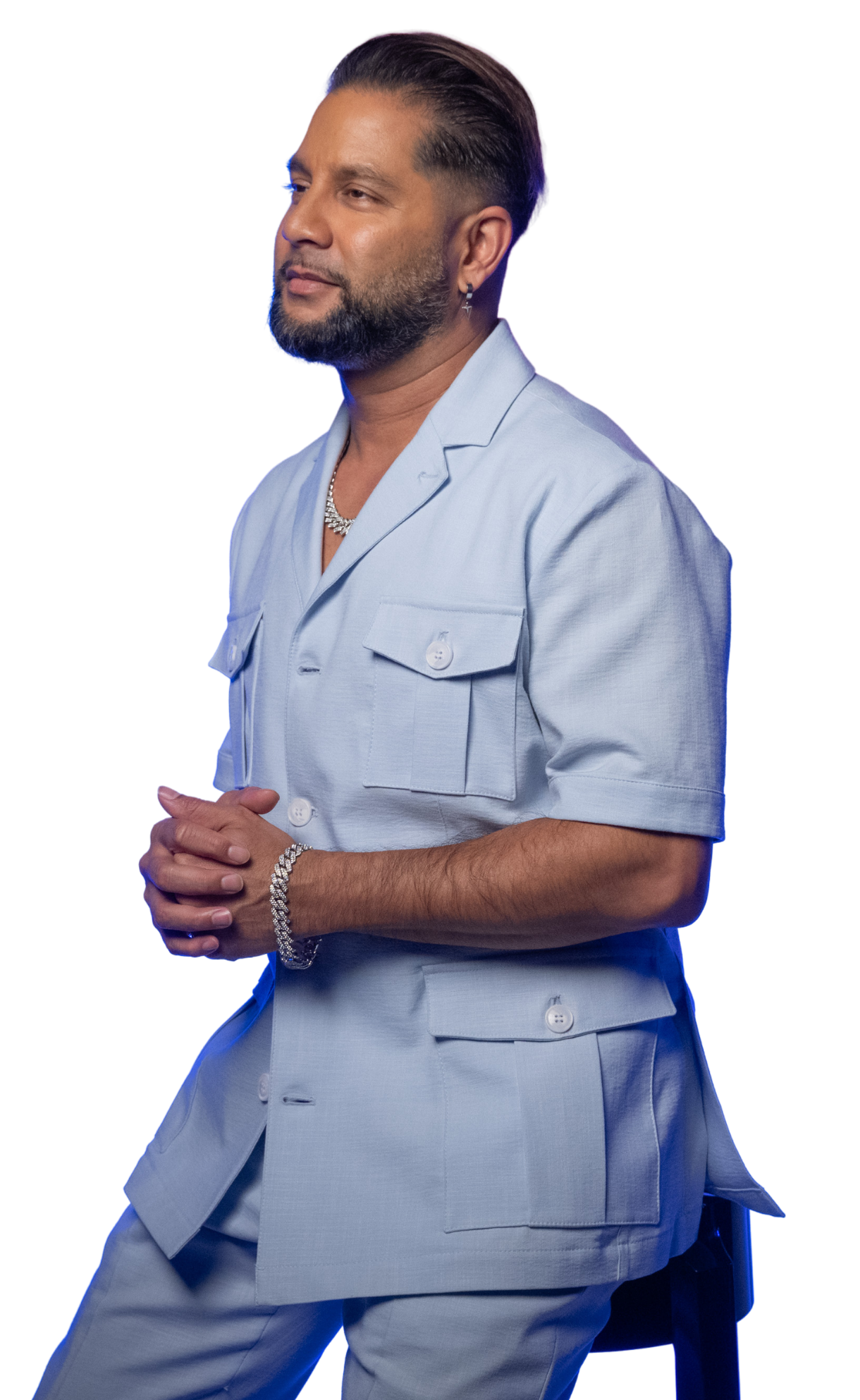 Devo Brown in a light blue outfit against a purple background