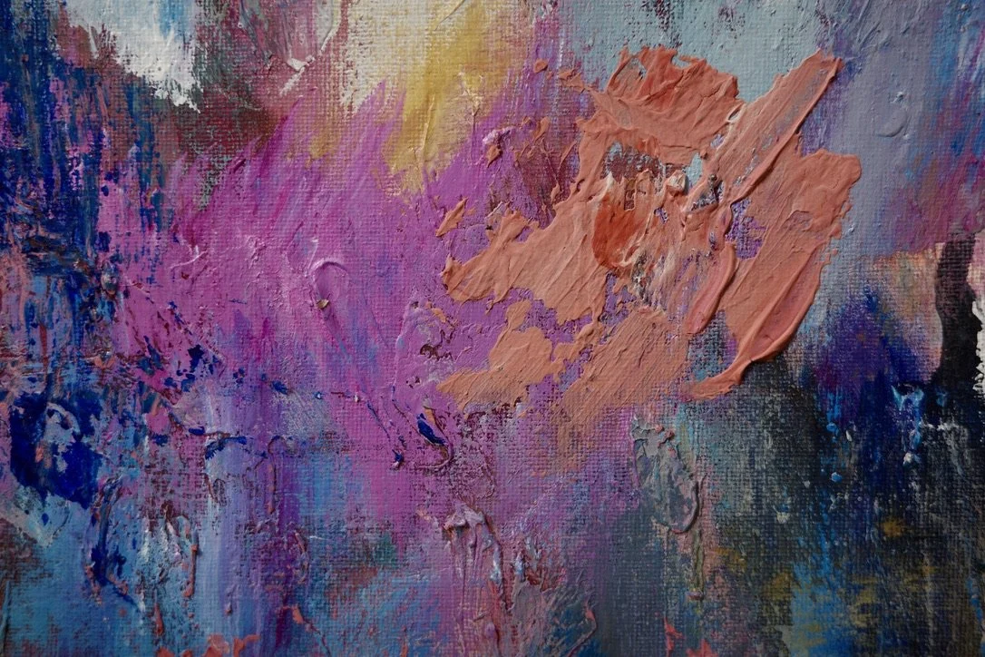 A closeup of an abstract painting featuring textured brush strokes of pinks, purples, blues and yellows.