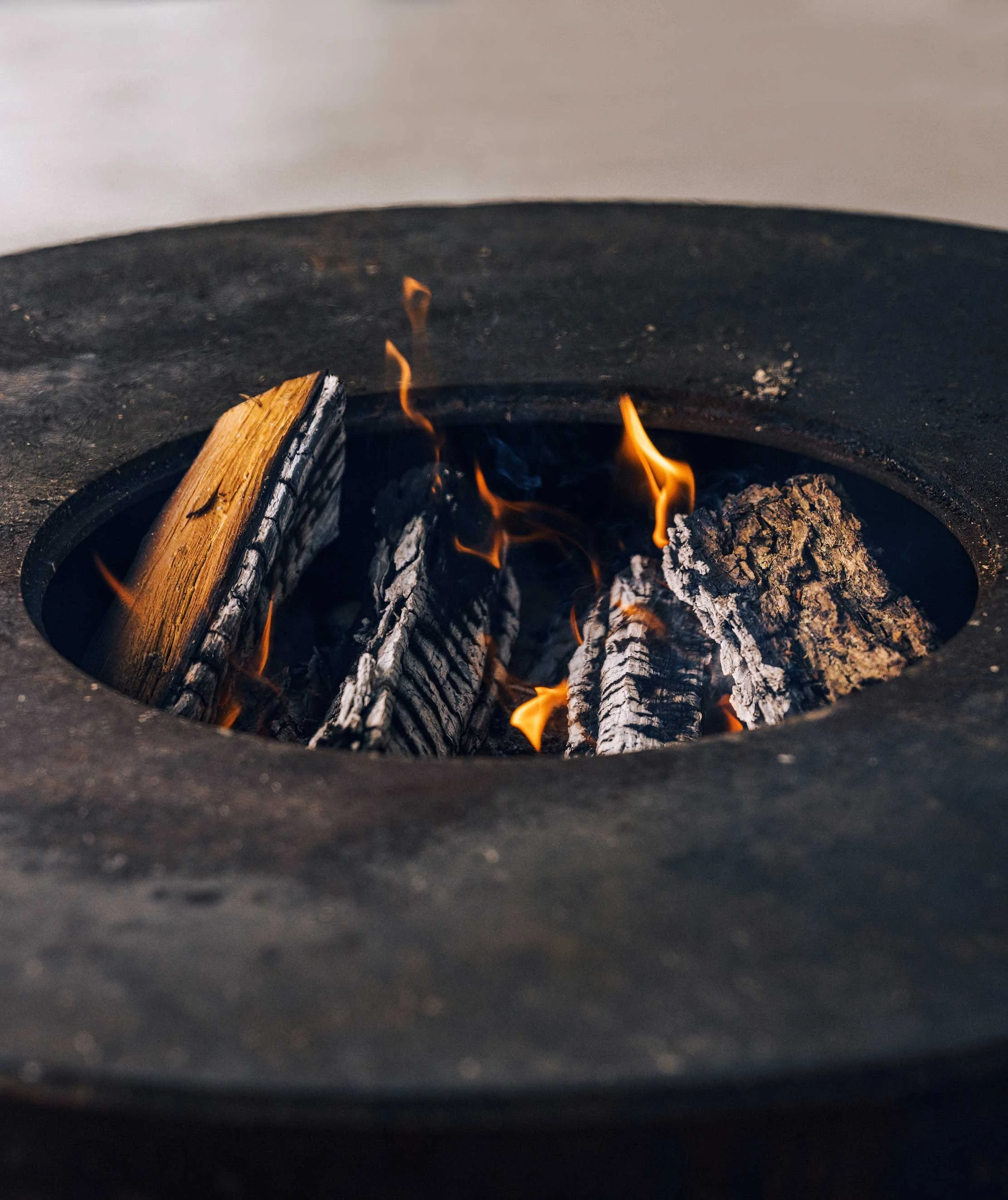 fire pit with burning logs viewed from above