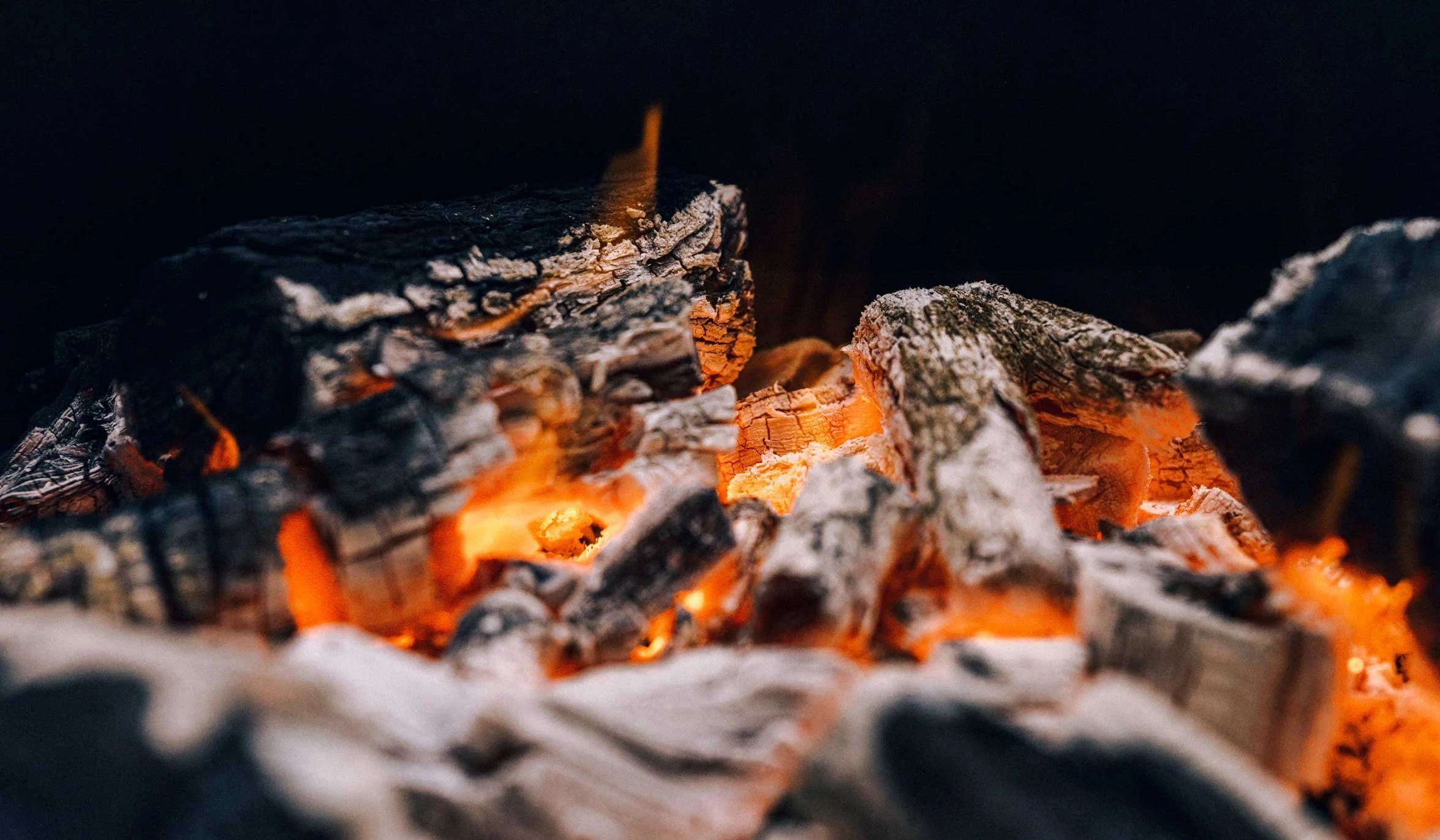 glowing fire embers and burning wood close up