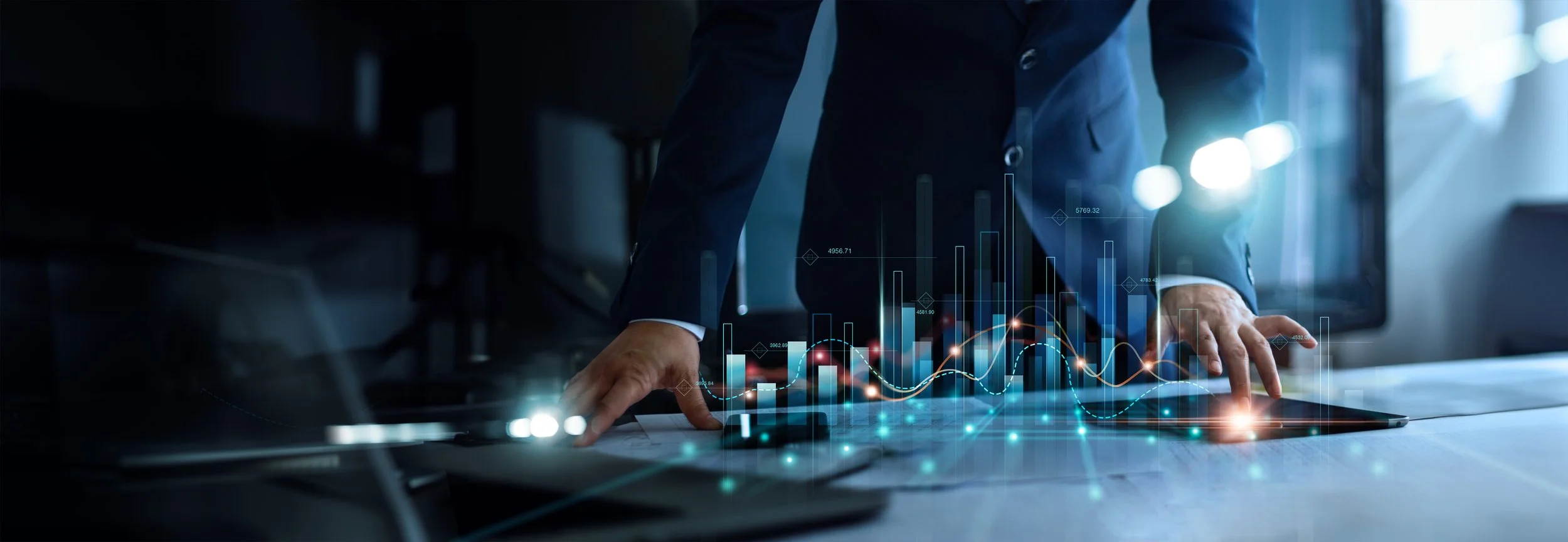 Person in business attire analyzing digital financial data with charts and graphs on a touchscreen device.