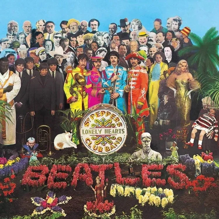 A large collage of The Beatles with multiple cutouts of their faces, surrounded by flowers, plants, and memorabilia. Central figures are dressed in colorful military-style suits, with a large drum that reads "The Beatles" and "Lonely Hearts Club Band." The word "BEATLES" is spelled out in flowers at the bottom.