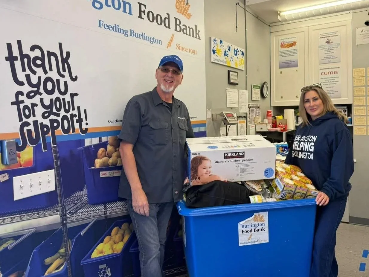 Image of BHB Director, Lindsay Gray, with a man at Burlington Food Bank following a donation drop off.