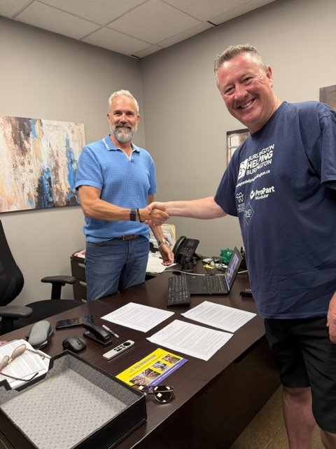 William Masters of Top Shelf Storage shaking hands with BHB's Sean Campbell upon official signing of partnership agreement.