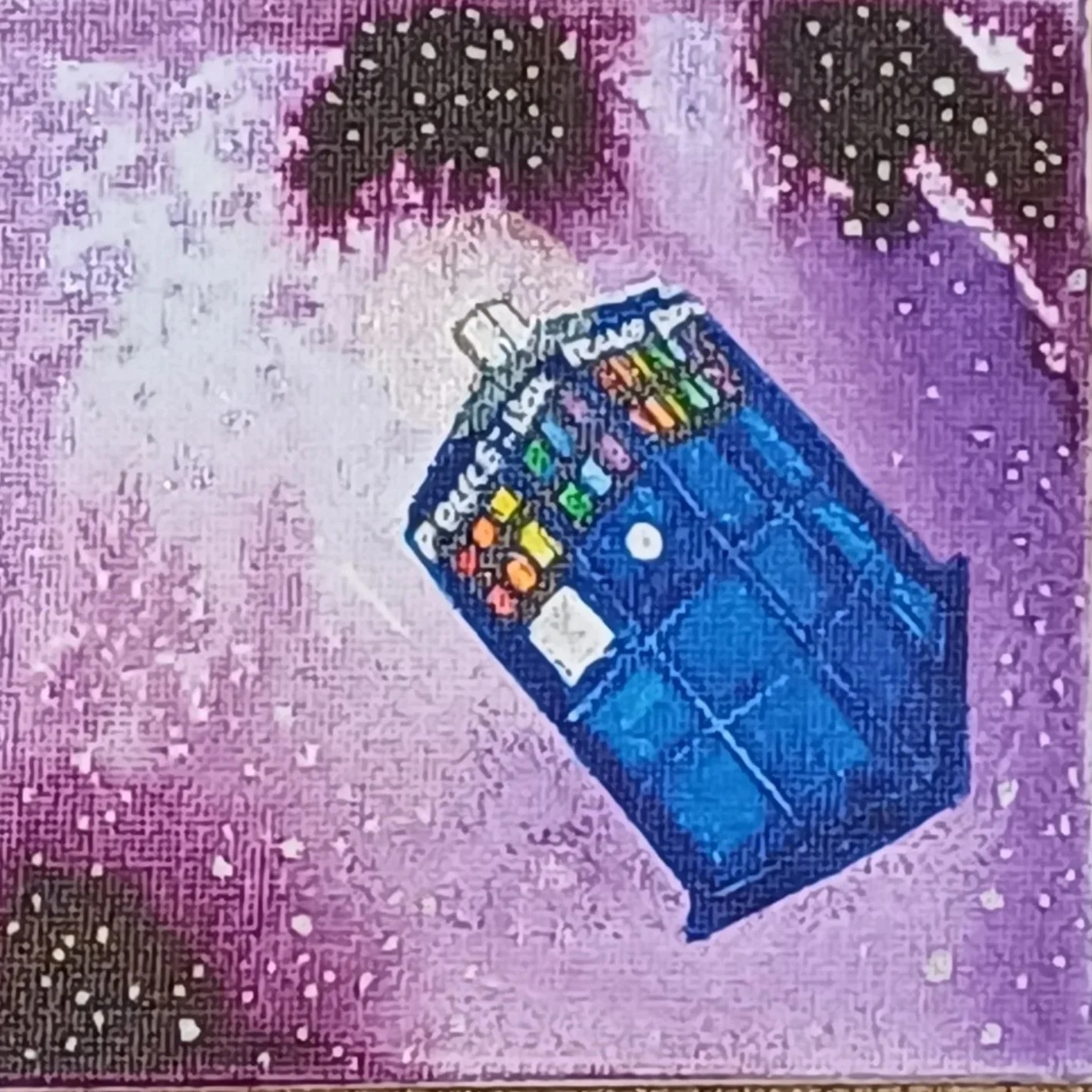 A pixelated illustration of a blue rubik's cube with colorful patterns on a purple and pink background with star-like dots.