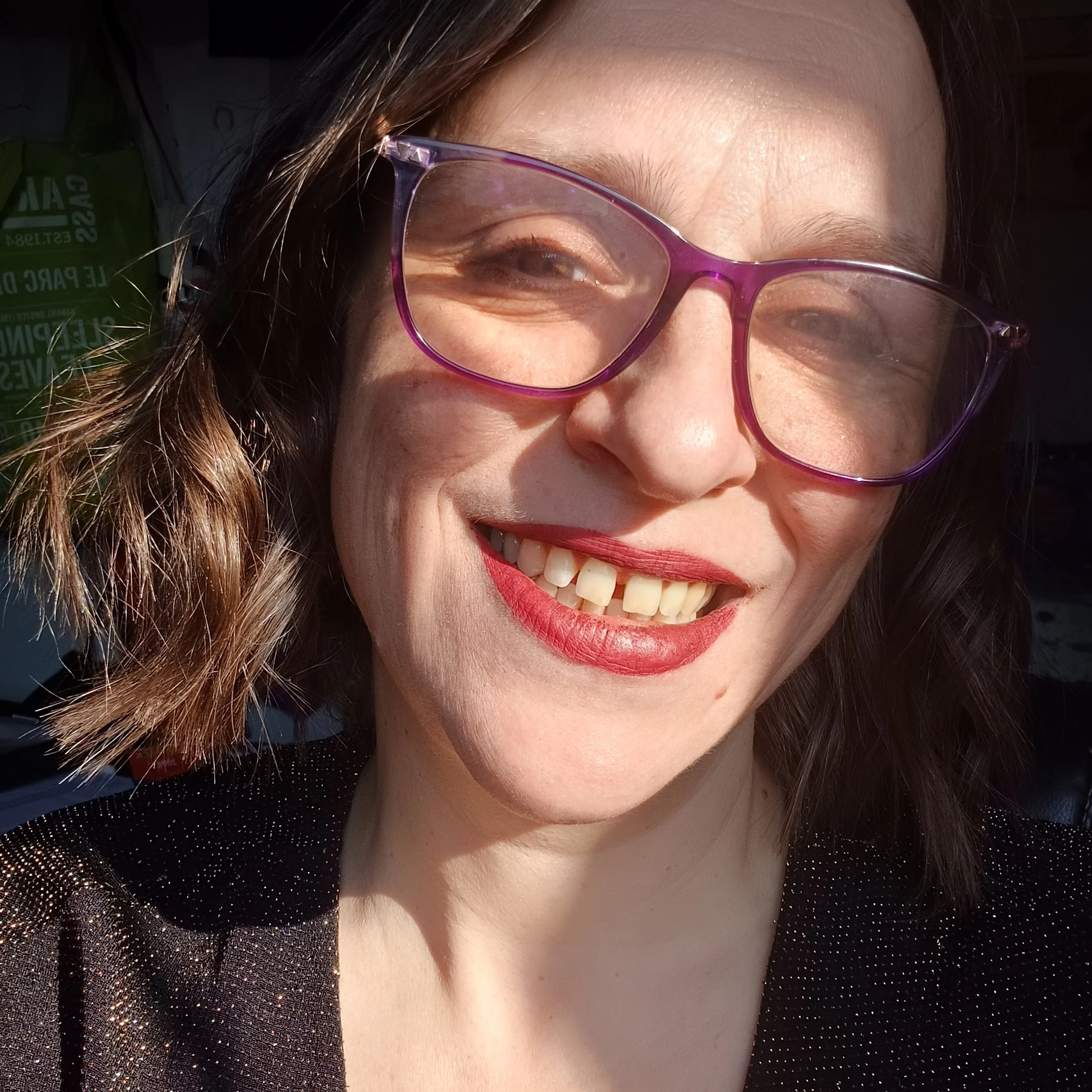 Artist Amy Hooton smiling woman red lips purple glasses