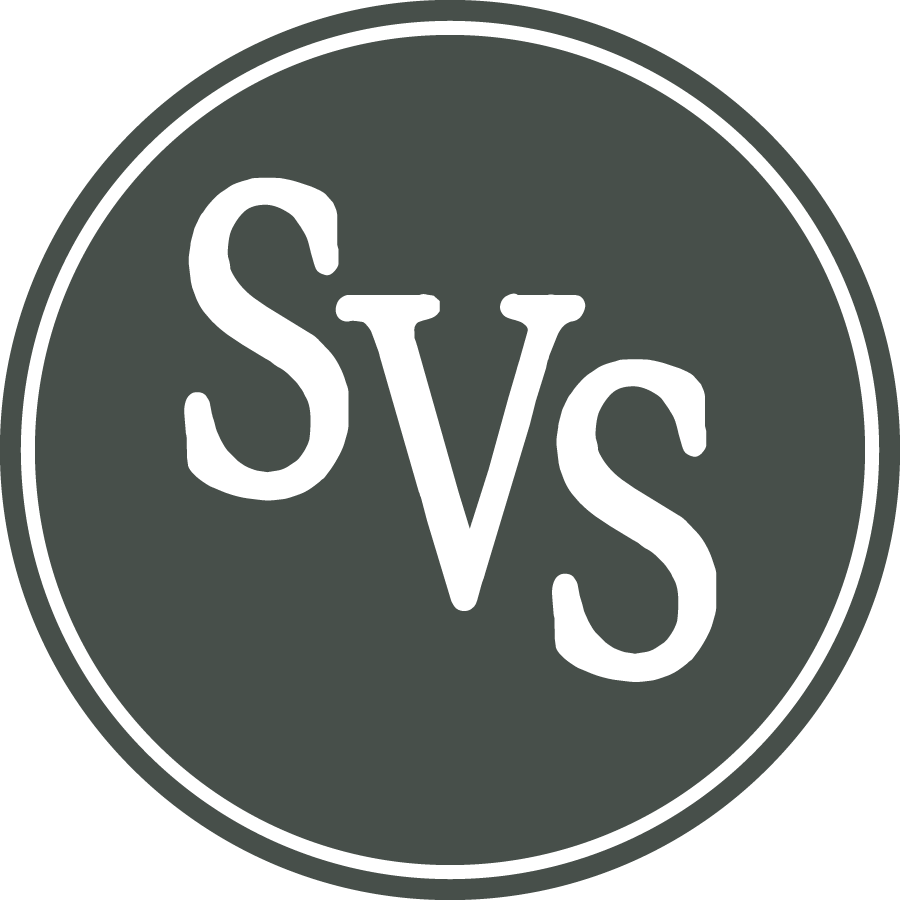 Circle emblem with a dark gray background and black border, containing the letters "SVS" in black.