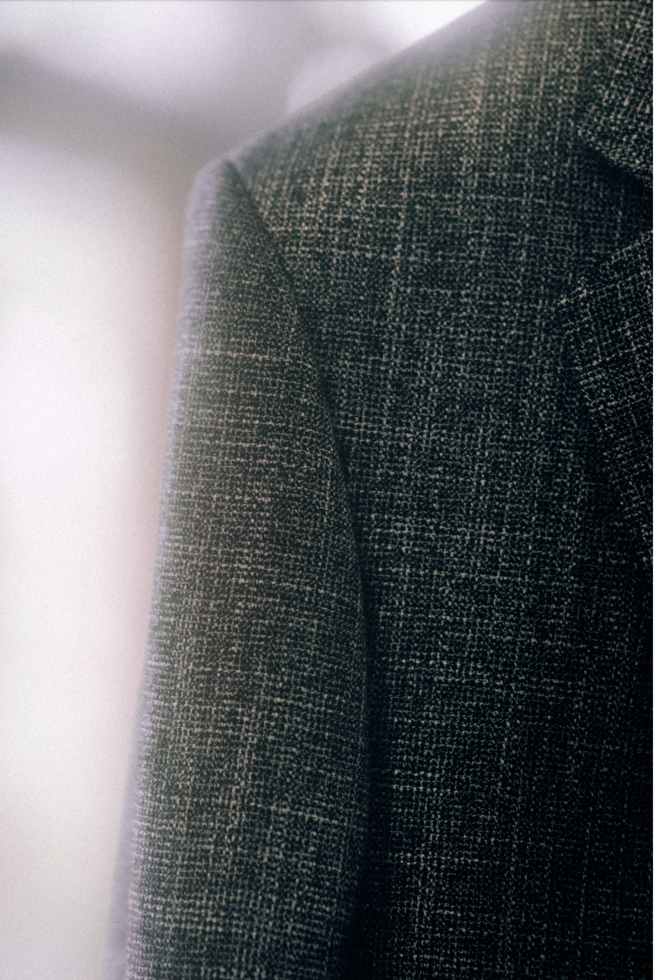 Close-up of a gray, textured sport coat in a bamboo fabric.